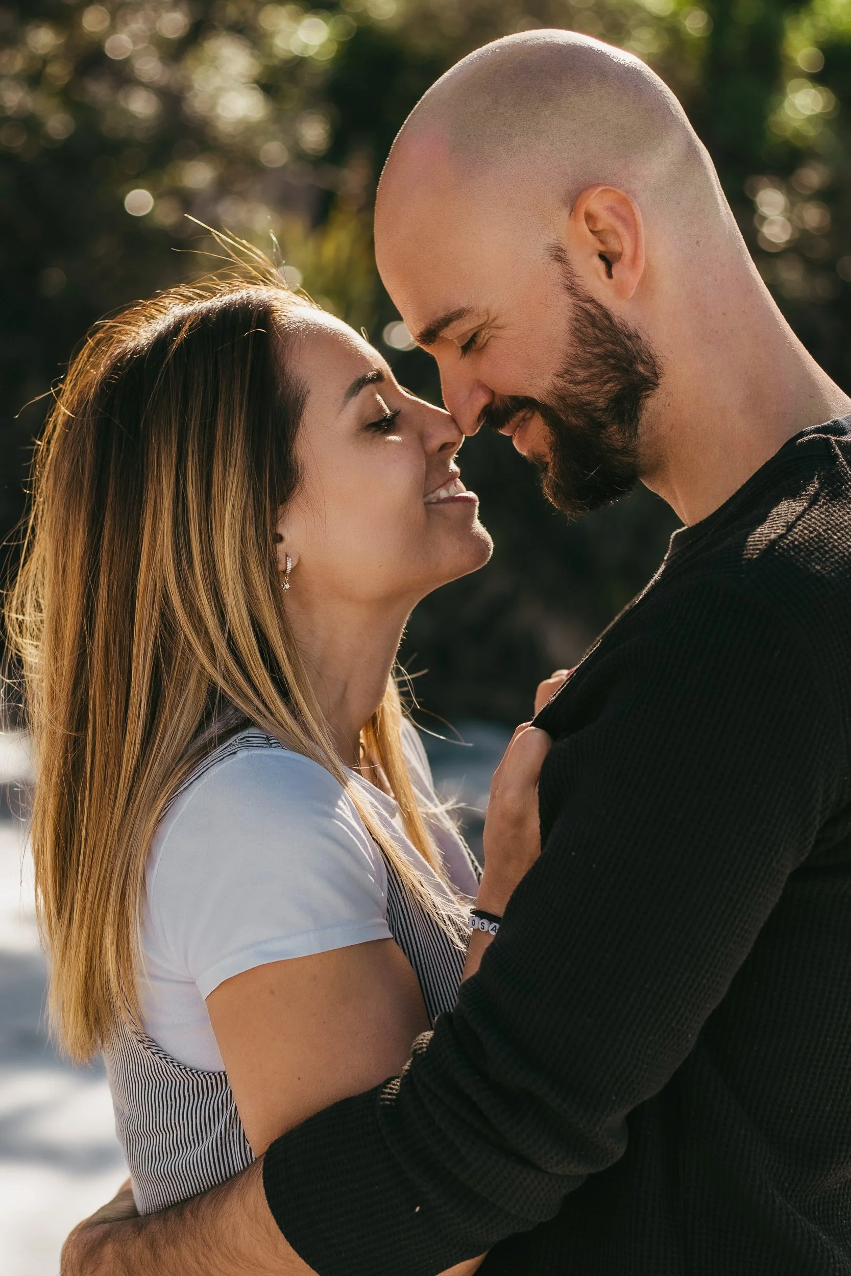 A couple kisses lovingly during their engagement session, showcasing intimacy in Austrlia