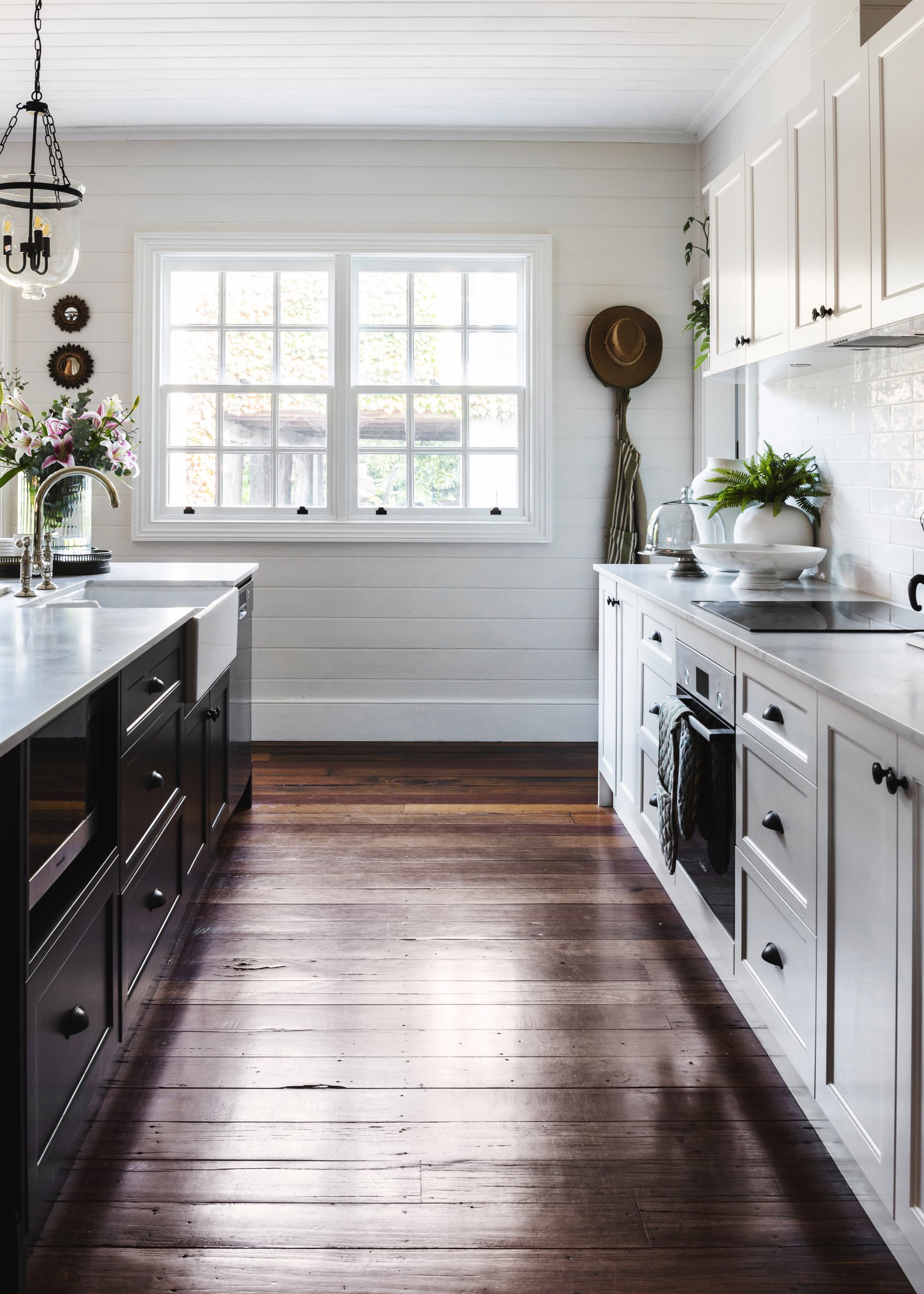 A modern farmhouse kitchen island with black details, exemplifying the sleek interior designs photographed by Diego Pinto in Sydney.