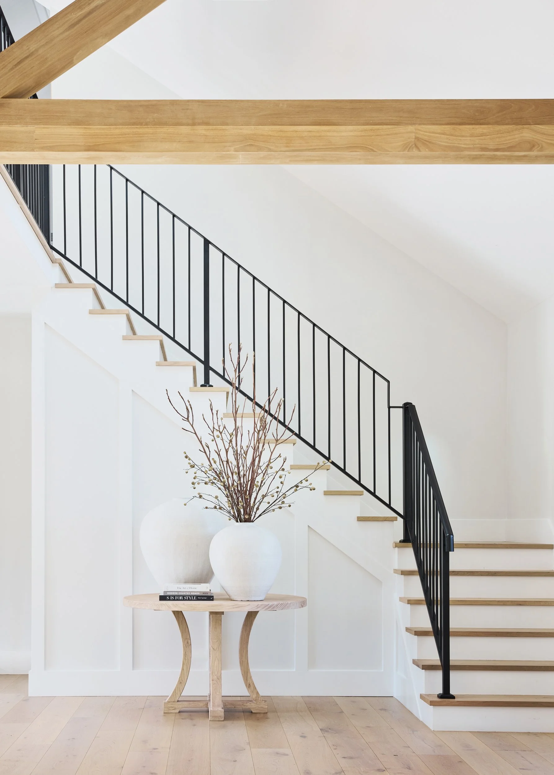 Premium entryway nook with round table and staircase, interior architecture photography Sydney NSW high-end

