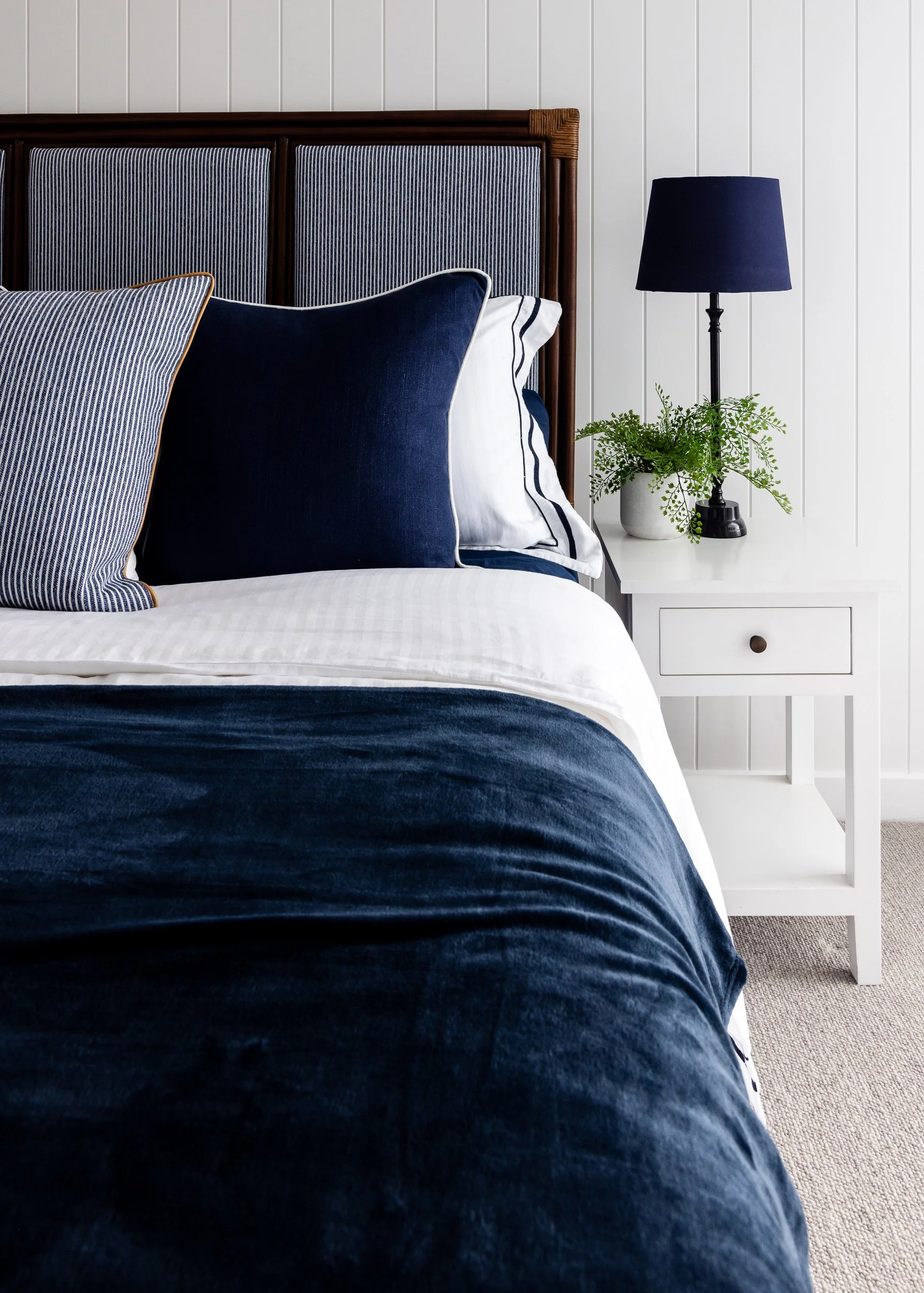 A modern coastal bedroom with navy accents, captured in a classic editorial style by Sydney's Diego Pinto.