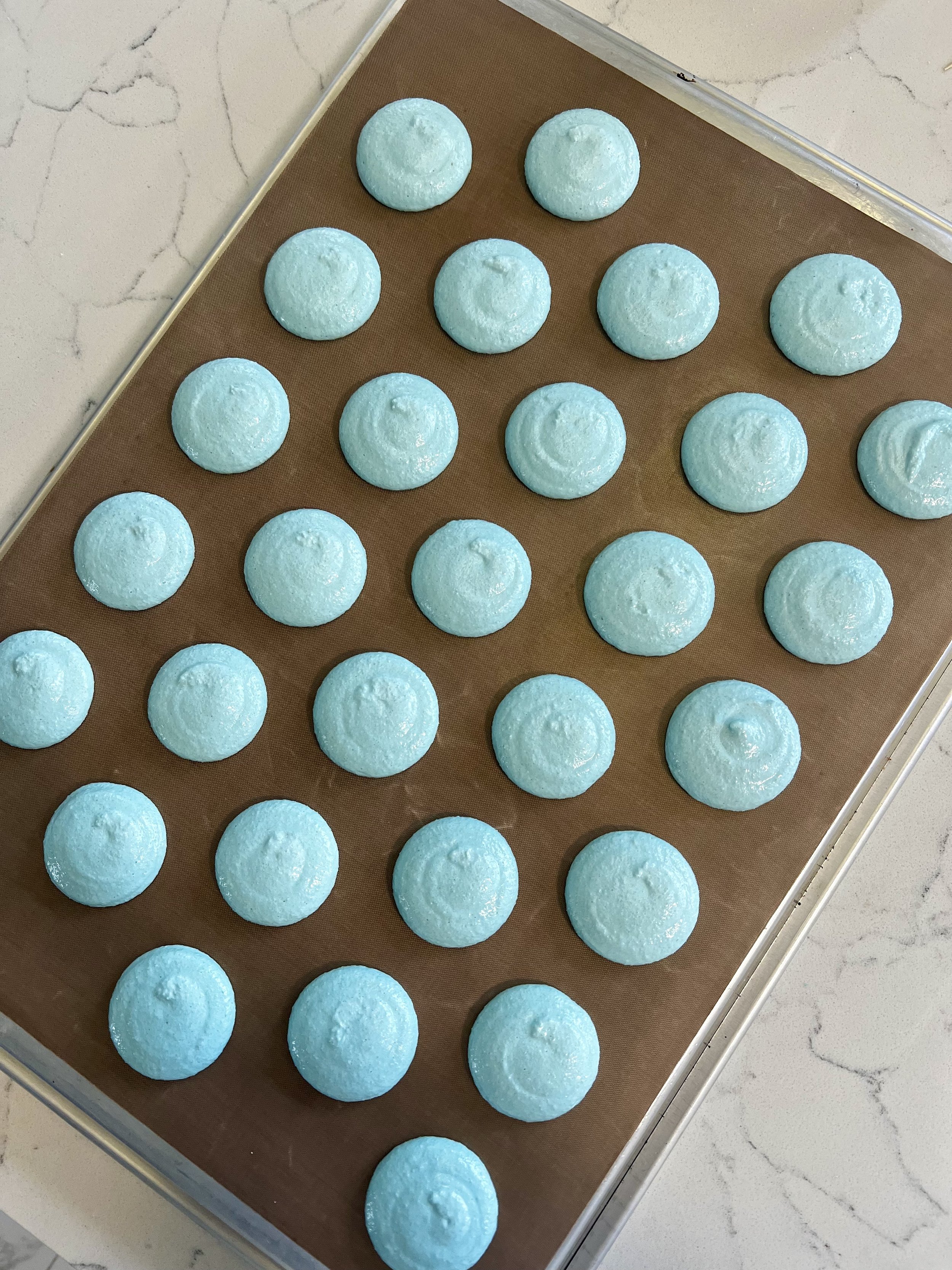 Macaron shells drying before baking