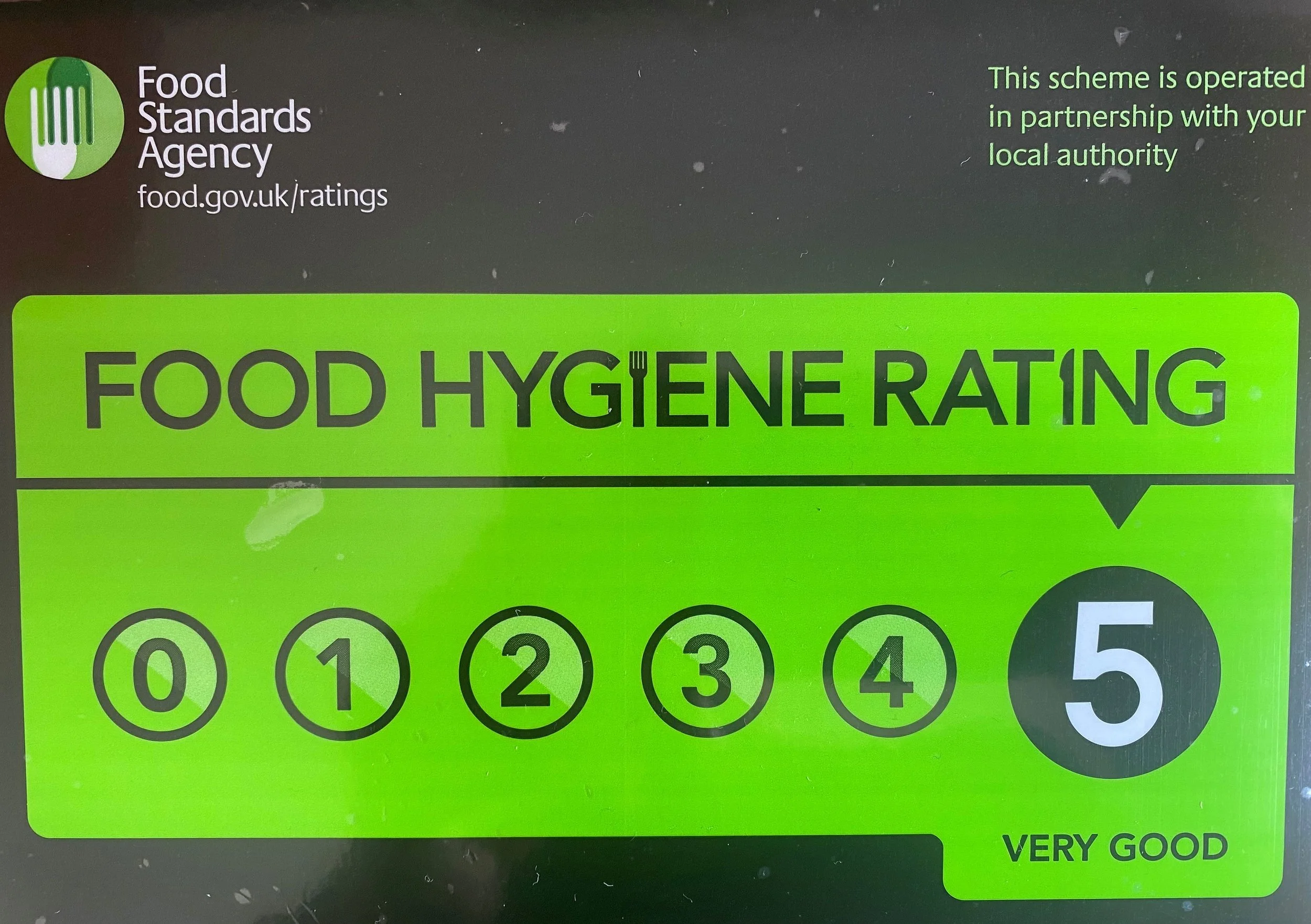 Food hygiene rating sticker from Food Standards Agency, with the rating of 5 labeled 'Very Good' on a black and green background.