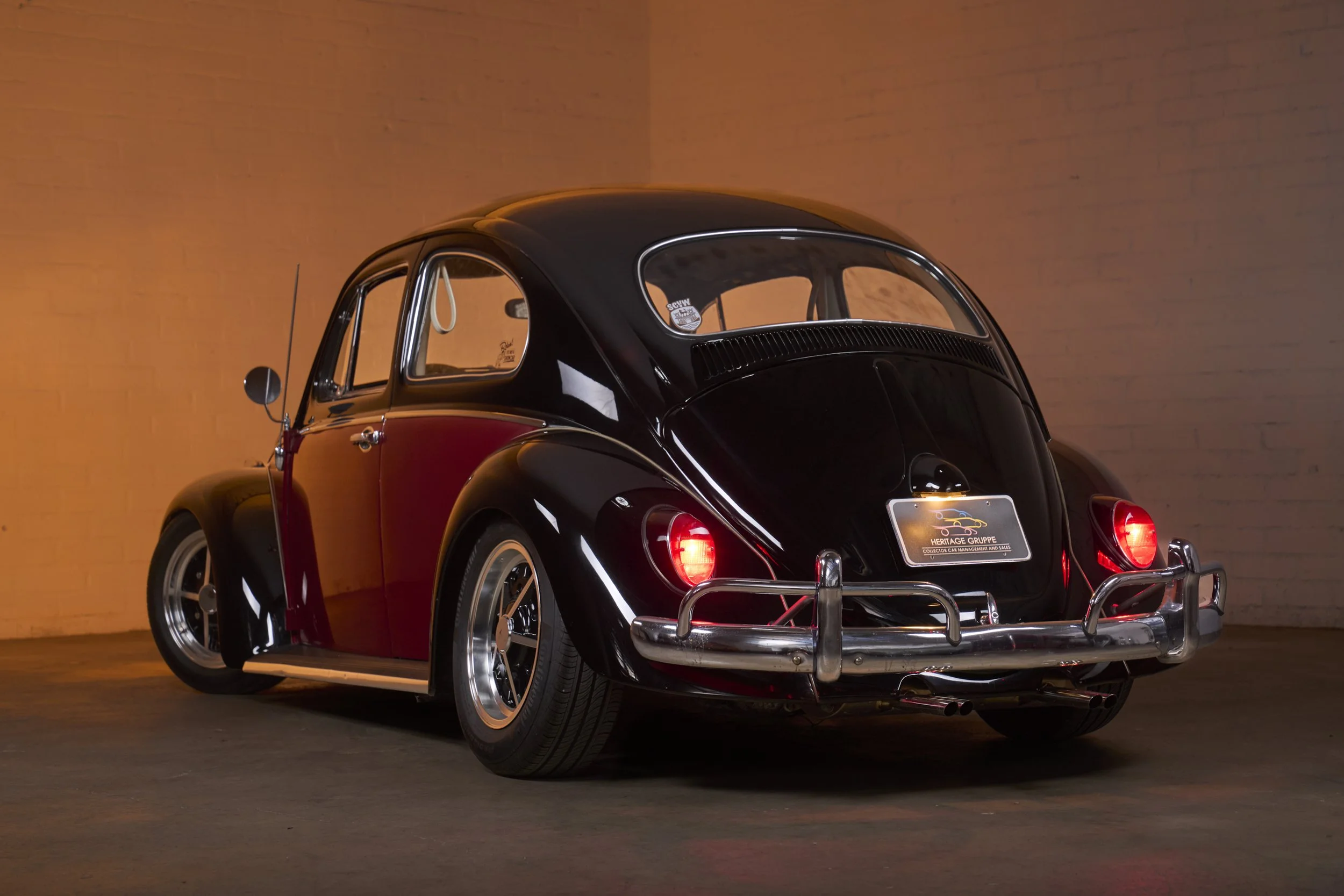 An automotive photograph of a black/burgundy 1964 Volkswagen Beetle Custom shot by Fenivision for Heritage Gruppe on location, in Los Angeles, CA. 