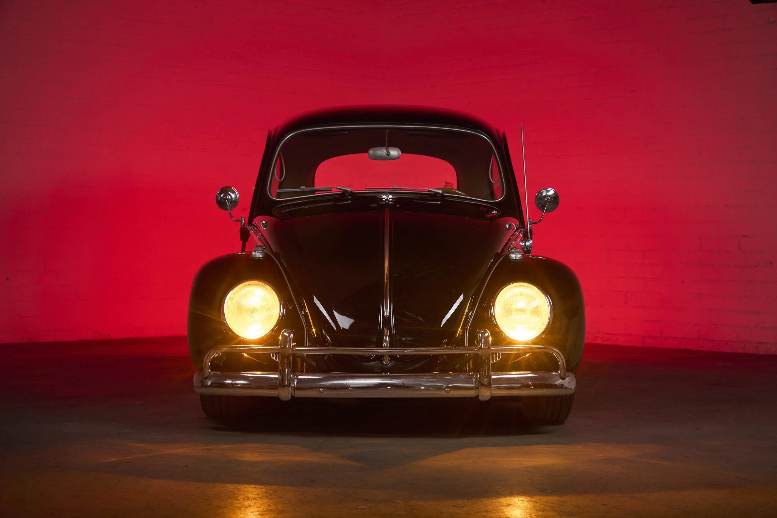 An automotive photograph of a black/burgundy 1964 Volkswagen Beetle Custom shot by Fenivision for Heritage Gruppe on location, in Los Angeles, CA. 