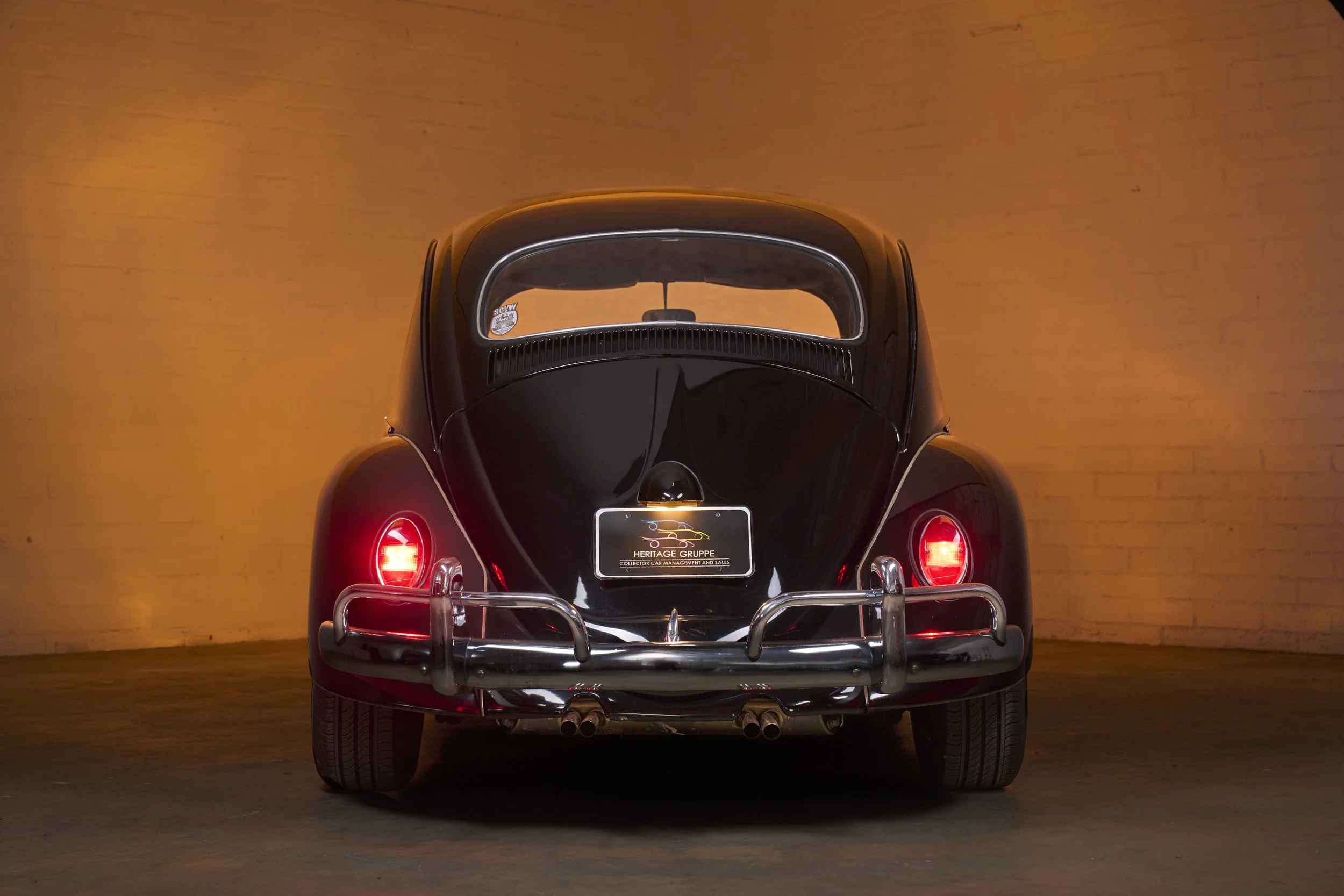 An automotive photograph of a black/burgundy 1964 Volkswagen Beetle Custom shot by Fenivision for Heritage Gruppe on location, in Los Angeles, CA. 