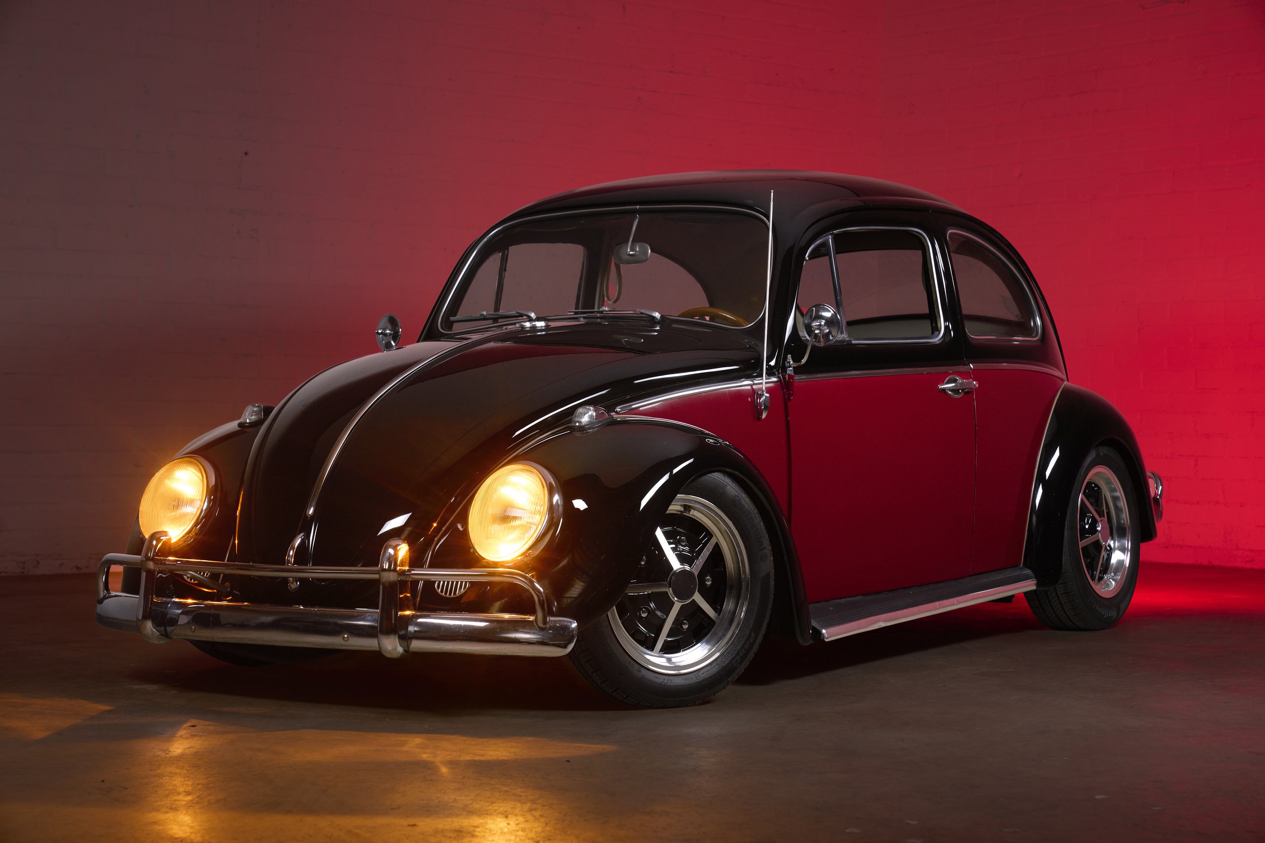 An automotive photograph of a black/burgundy 1964 Volkswagen Beetle Custom shot by Fenivision for Heritage Gruppe on location, in Los Angeles, CA. 
