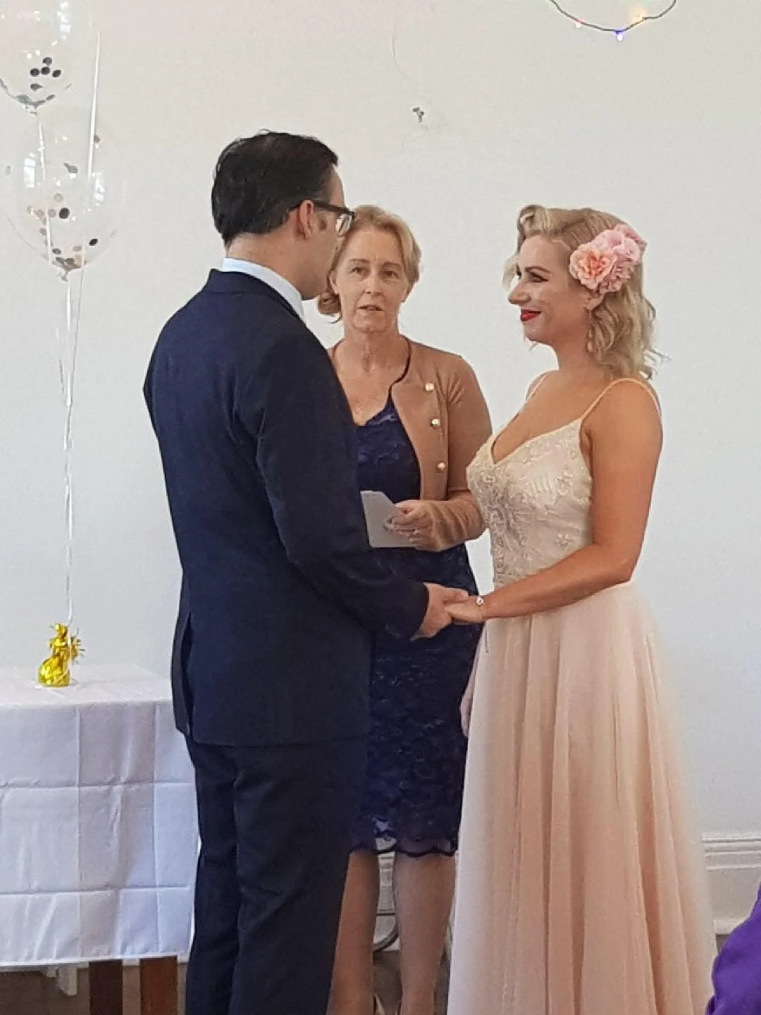 bride & groom with celebrant during wedding ceremony