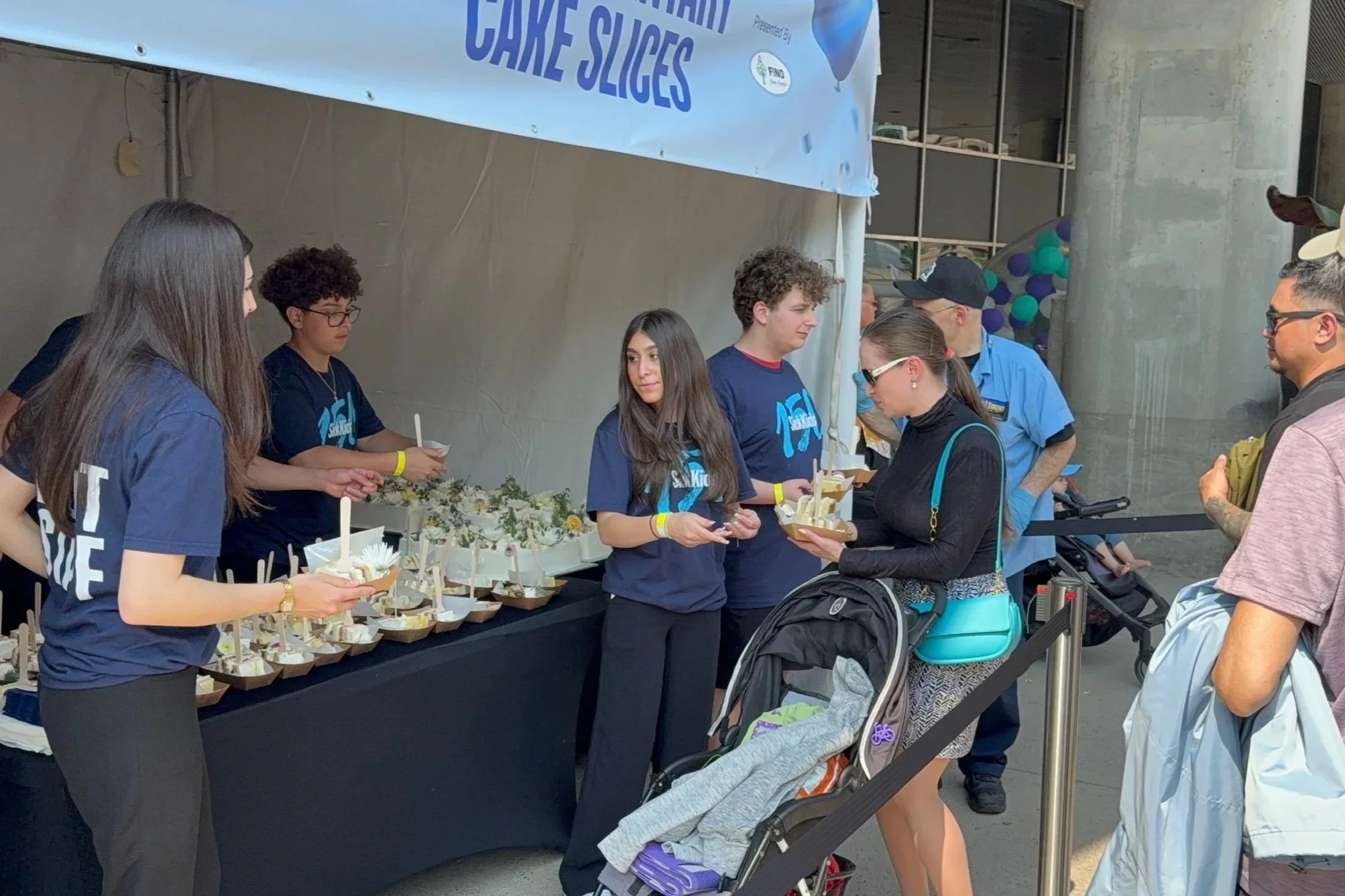 SickKids150HandingOutSlices.jpg