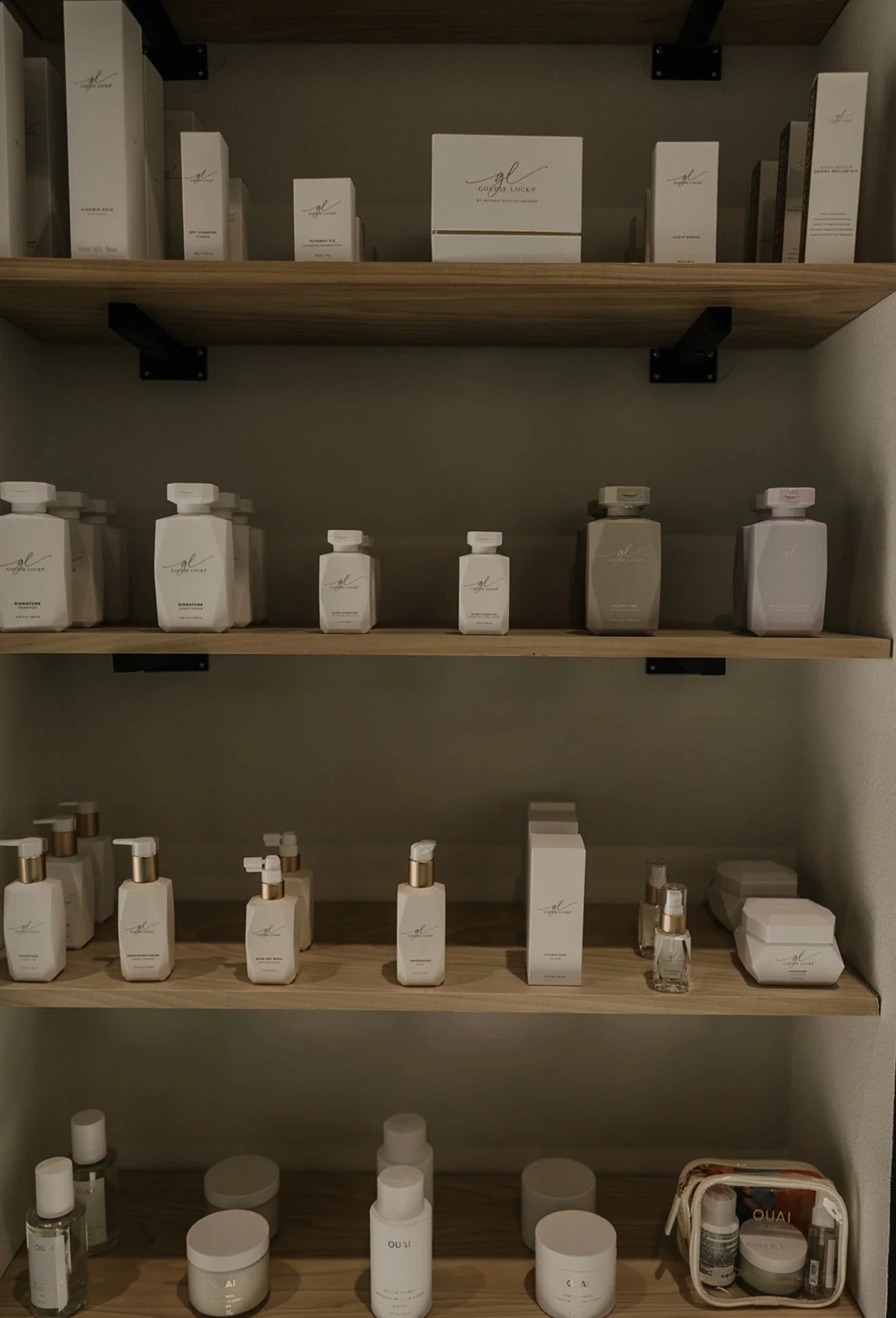 Cinematic interior view of The Industry CR luxury hair salon in Cedar Rapids, showcasing modern styling stations and a high-end atmosphere.