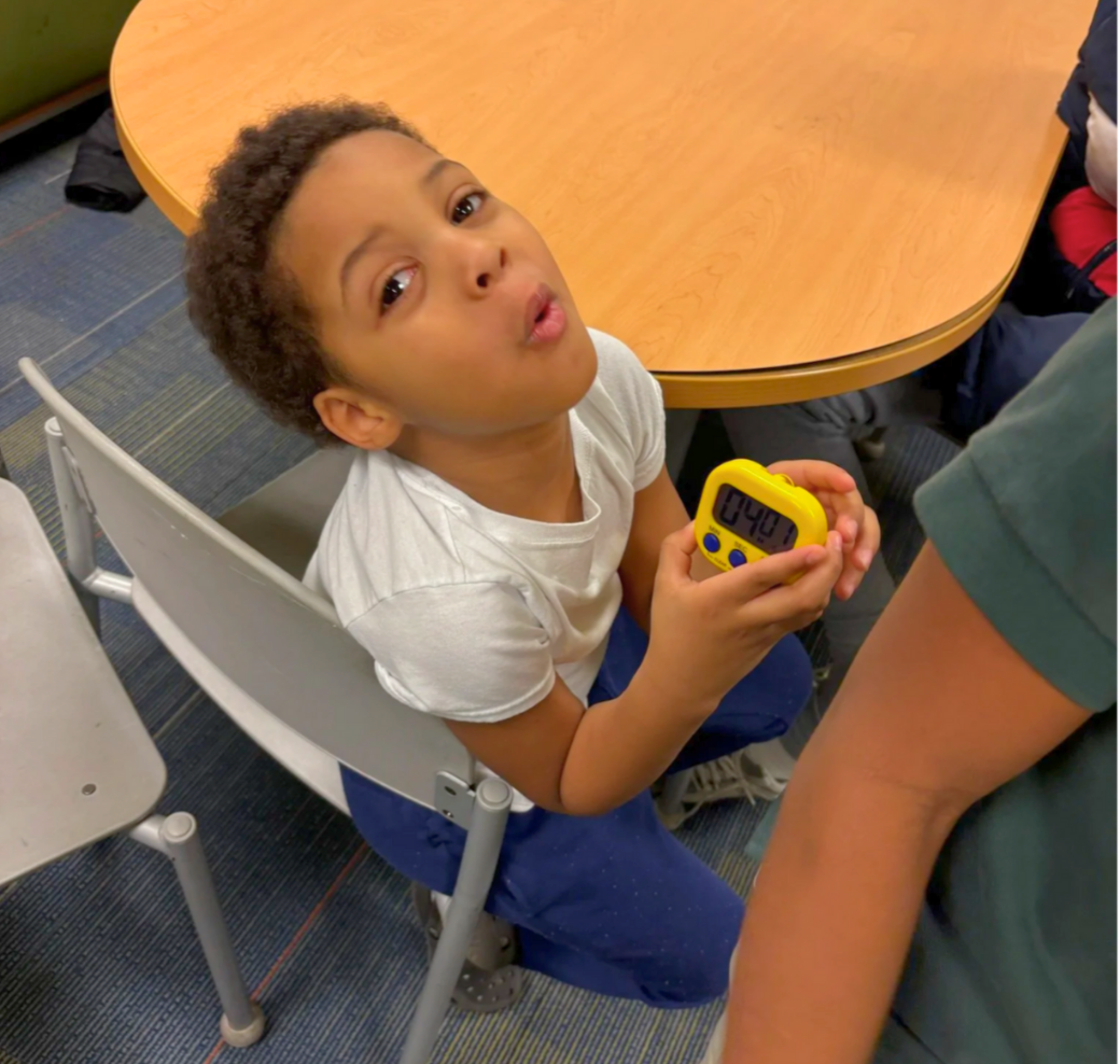 young boy with yellow timer