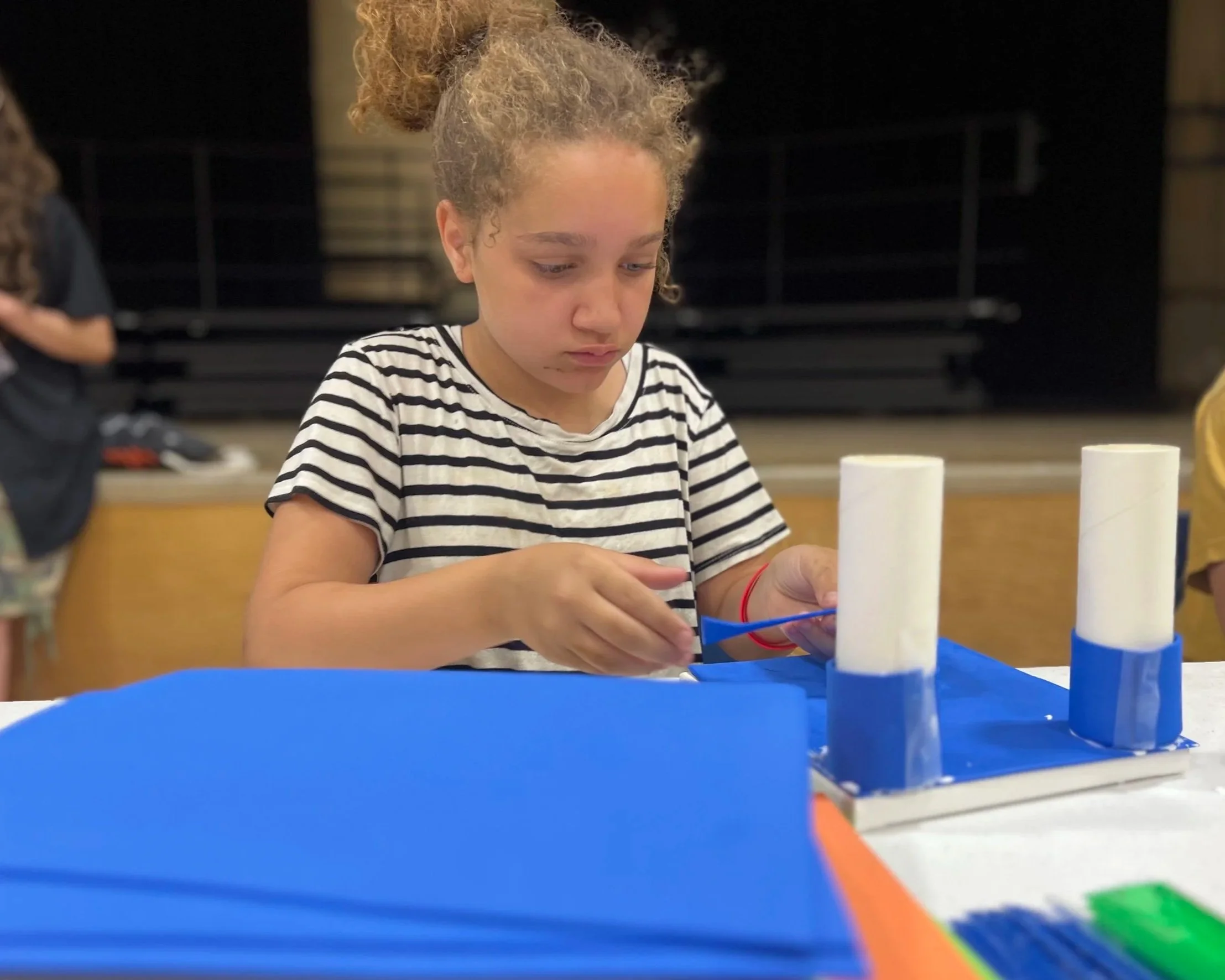 girl creating sports gear prototype with paper materials