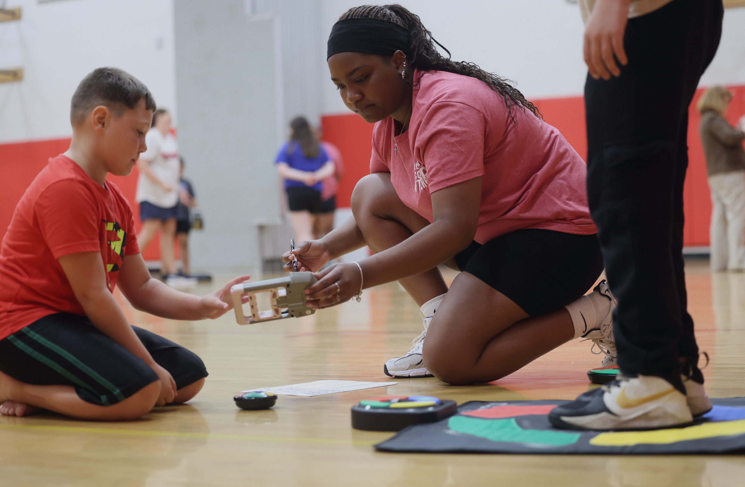 boy and instructor with tech equipment