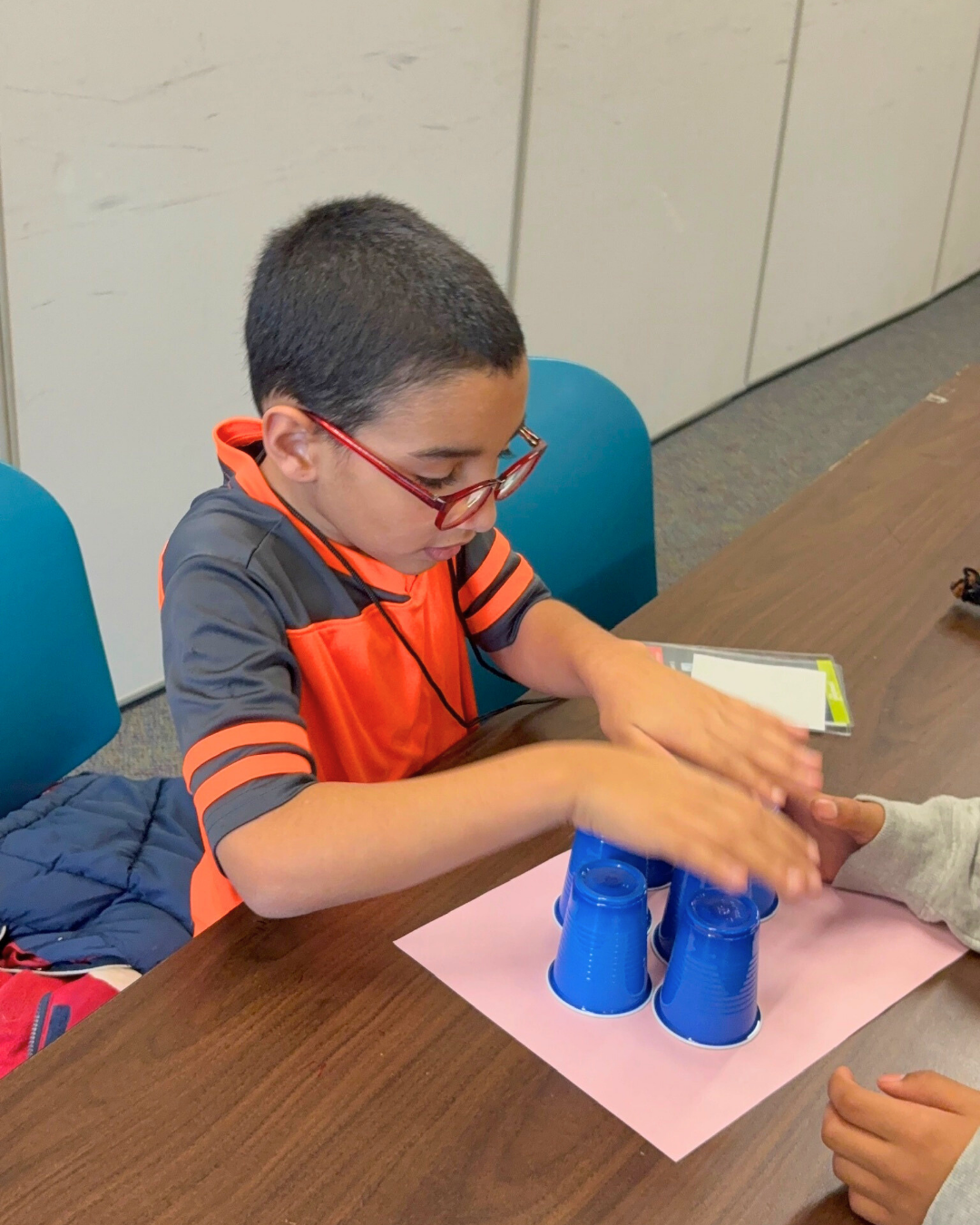 boy builds tower with paper.png