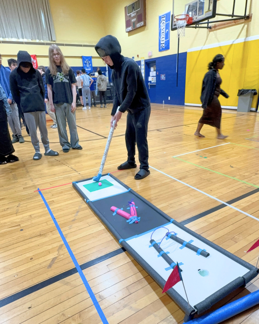 Teen play on Mini Golf Course they Built.png