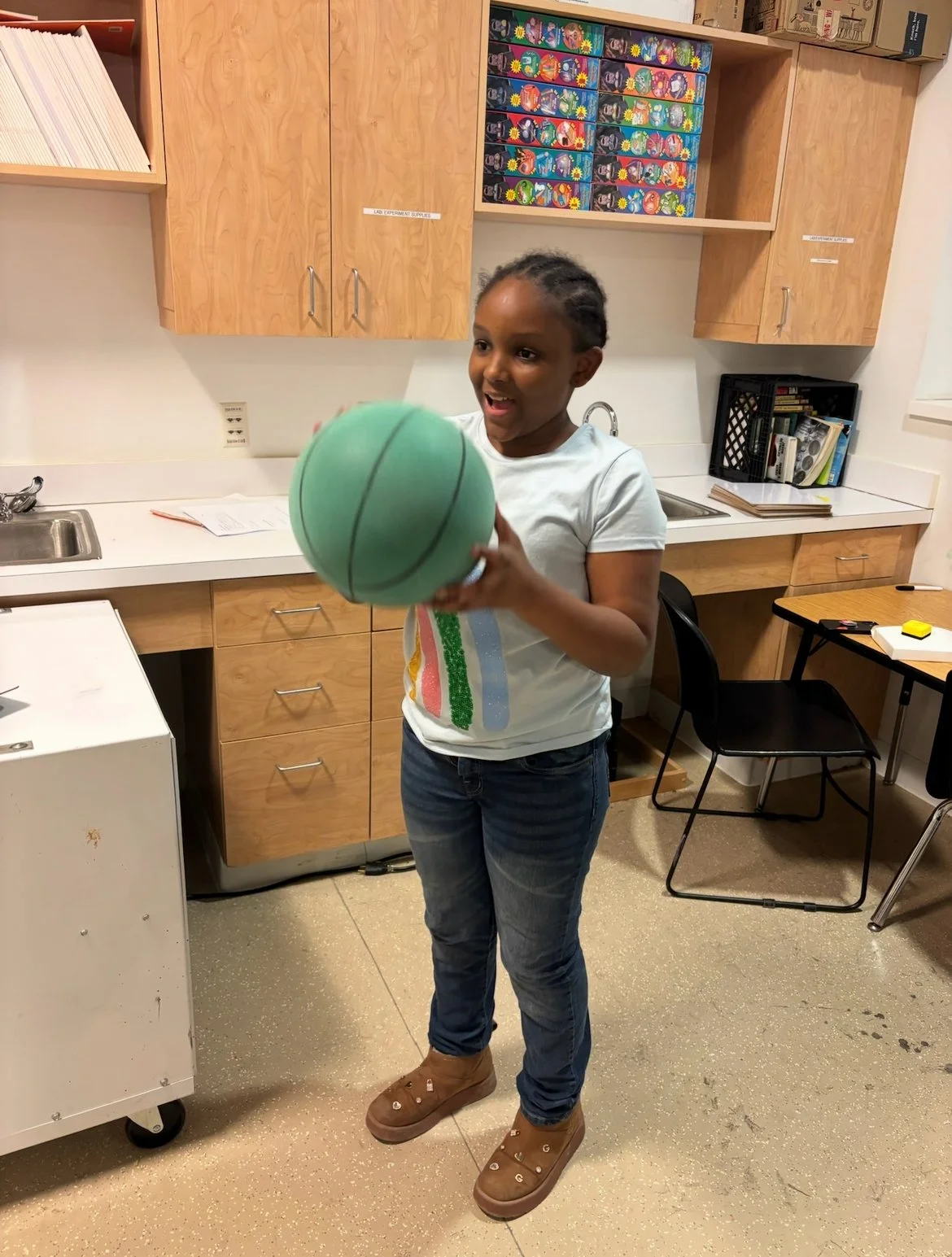 Girl holding green basketball