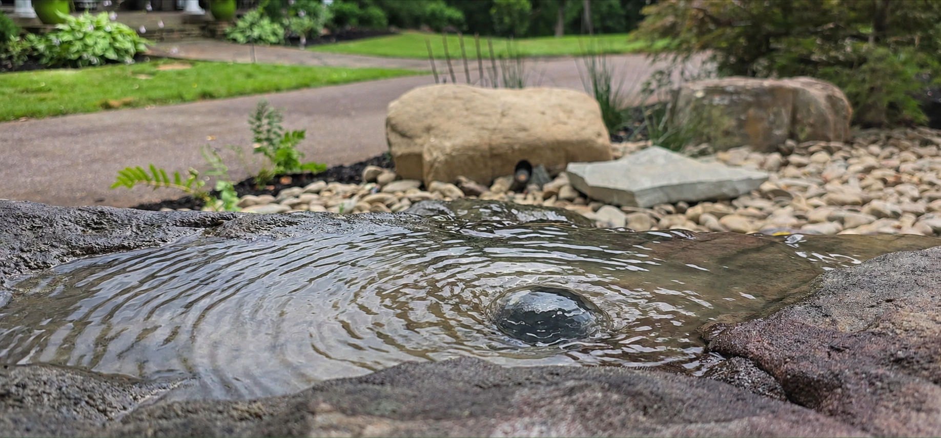Based on the character of the boulder, we found the exact location to be core drilled in order to create the gentle pool of water serving as the natural bird bath. 