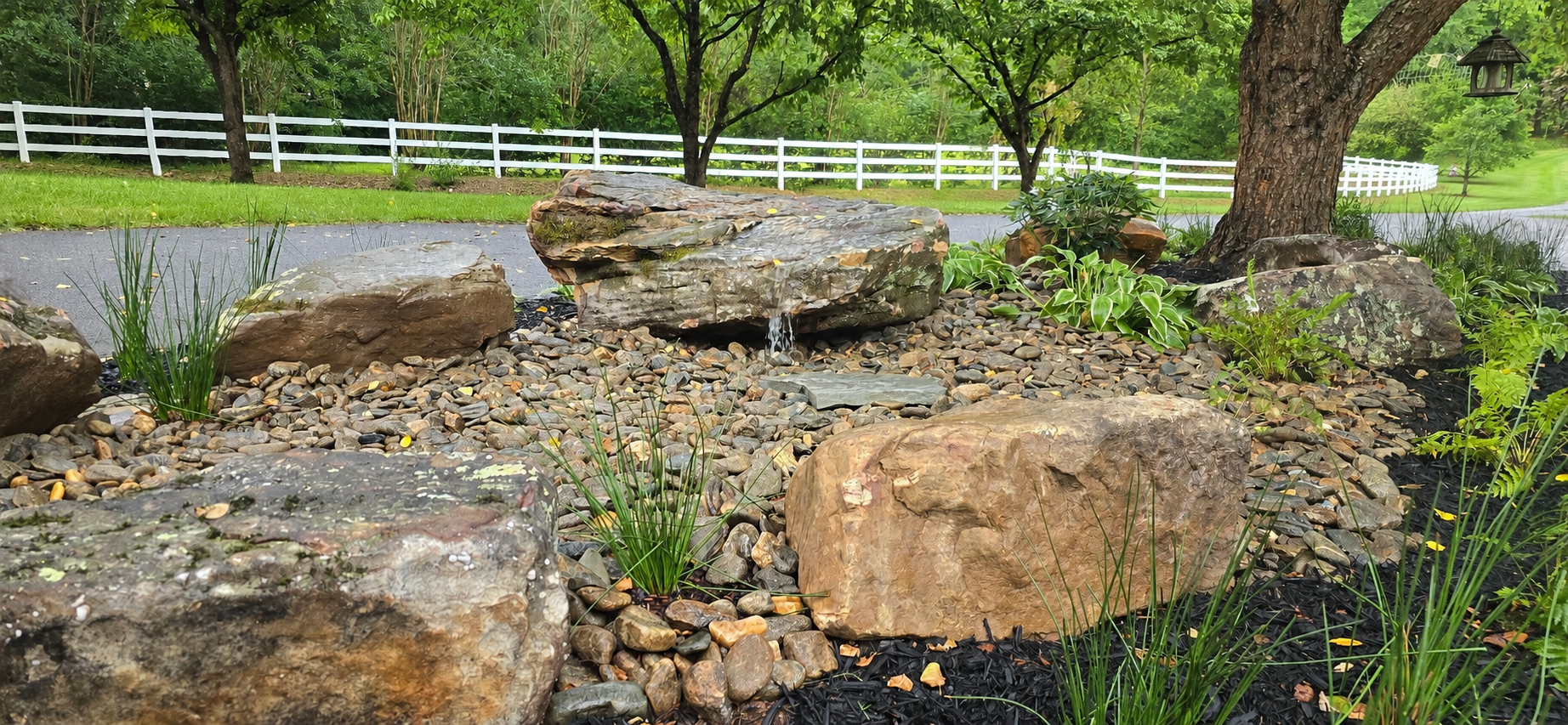 Carefully placed boulders creates a natural hardscape to welcome birds for the resident to enjoy. 