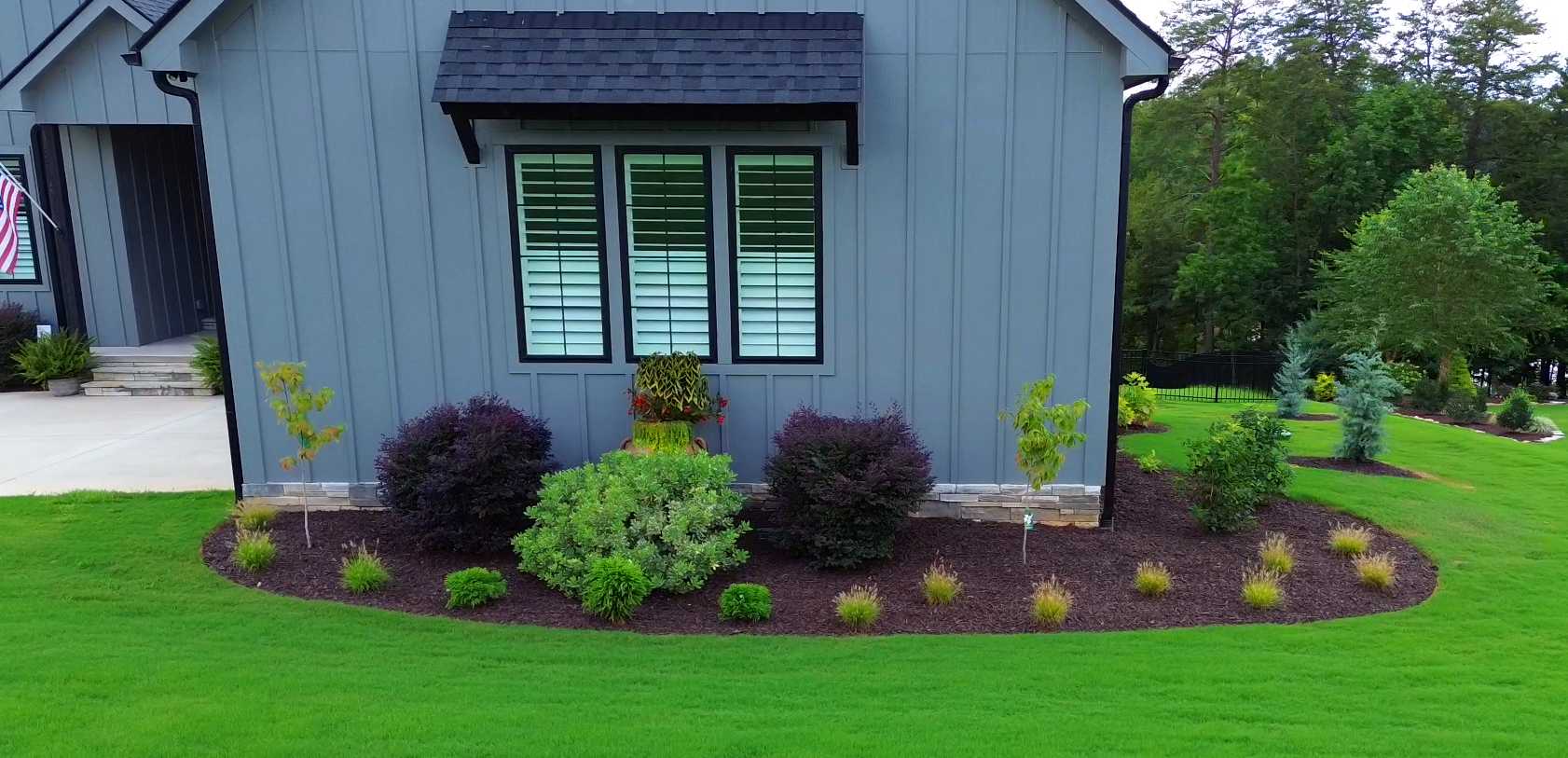 The finished landscape reveals its full structure—layered plantings, curated spacing, and a graceful bed line that perfectly anchors the home.
