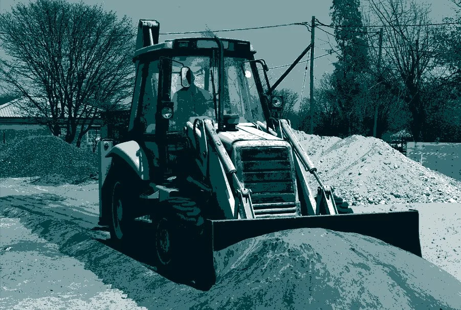 Tractor, pushing dirt on construction site