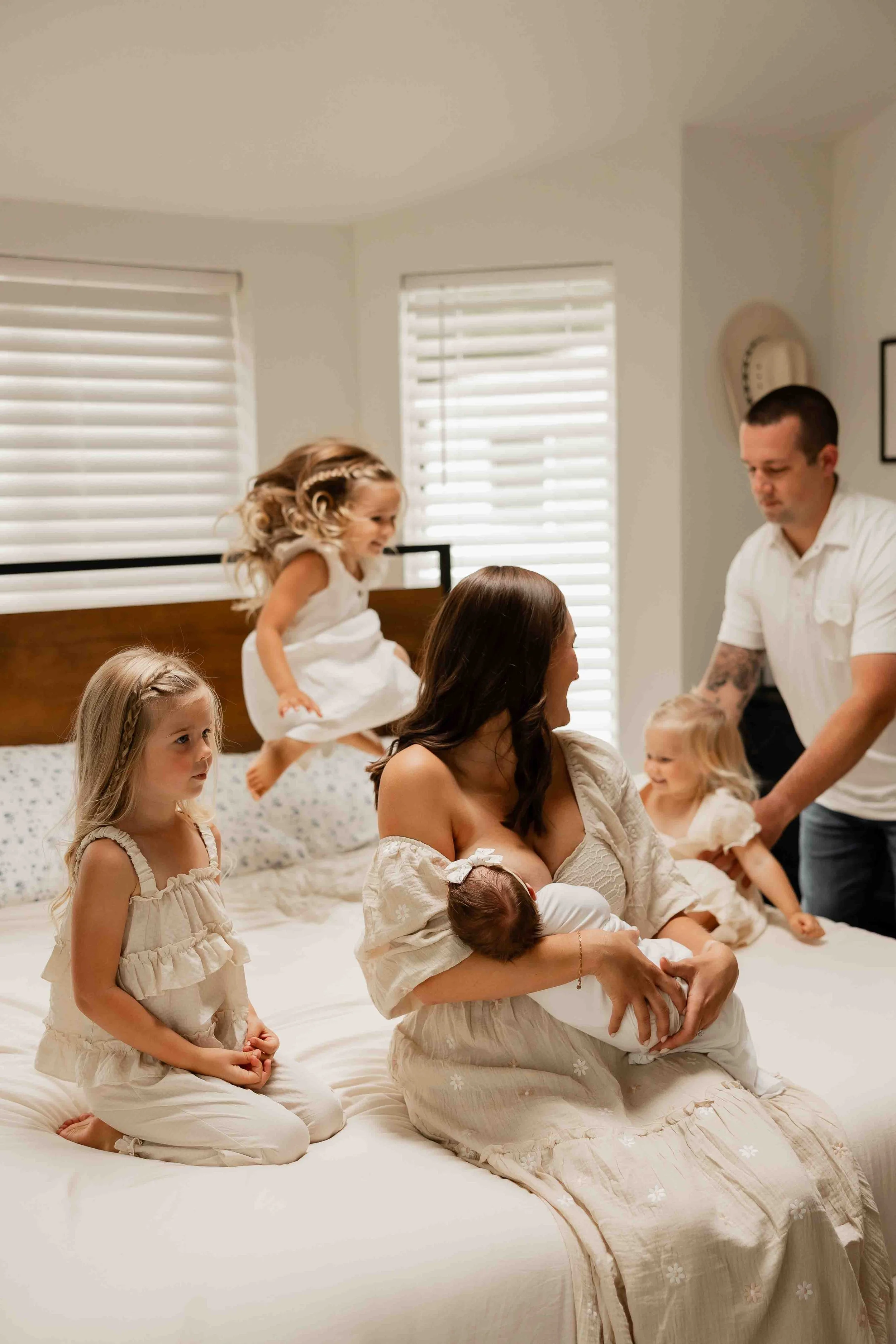 Family playing on bed during family photography session