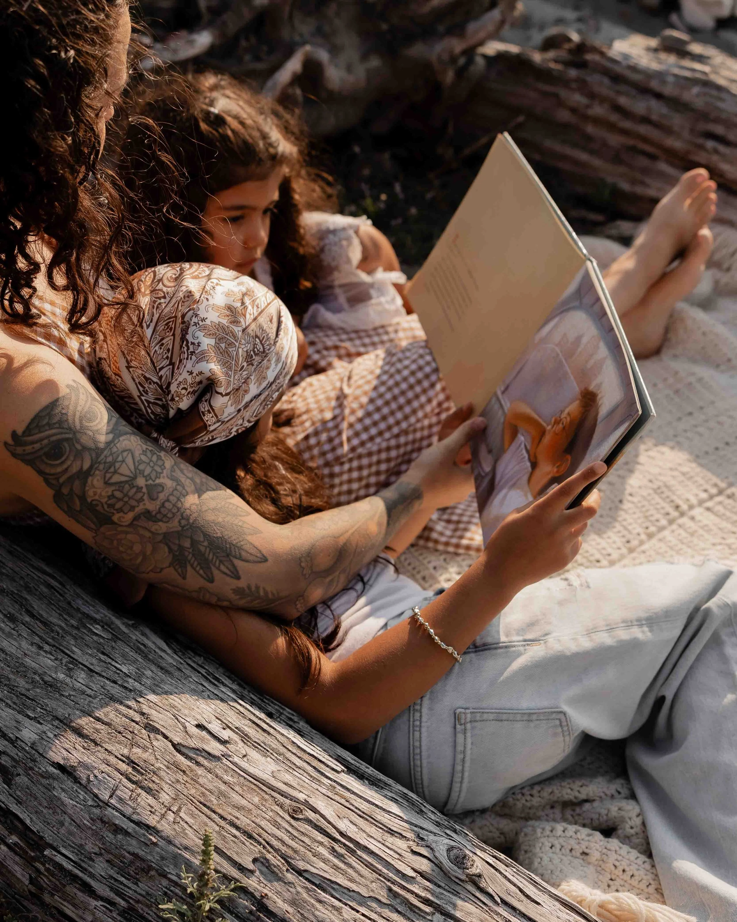 Mother reading to children during beach family photo session