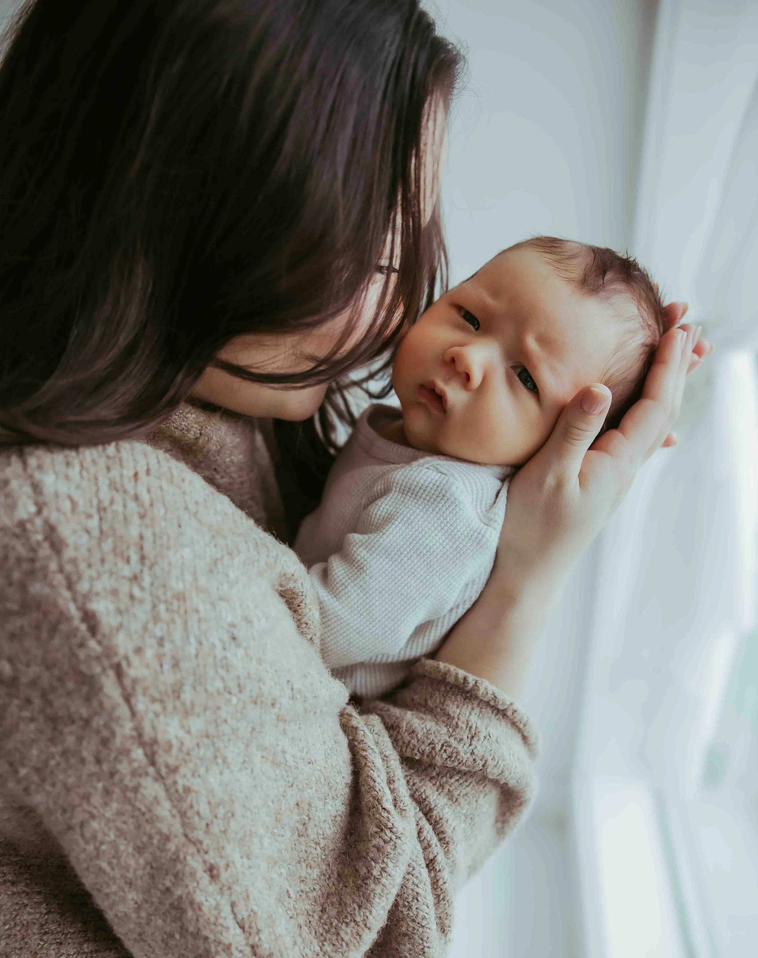 Mother snuggling newborn in Lynden, Washington 