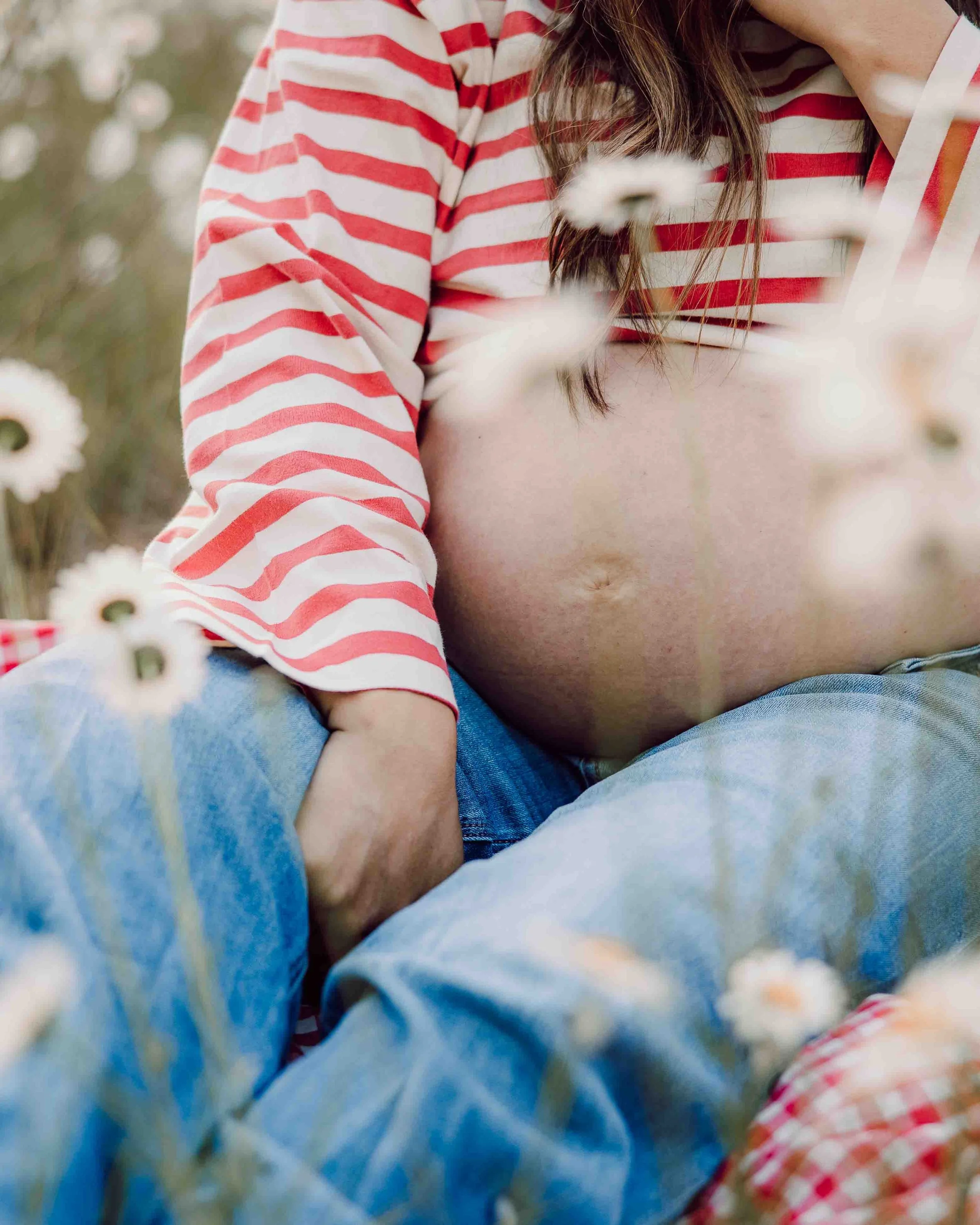 Pregnant mother in flower field at sunset in Blaine, Washington