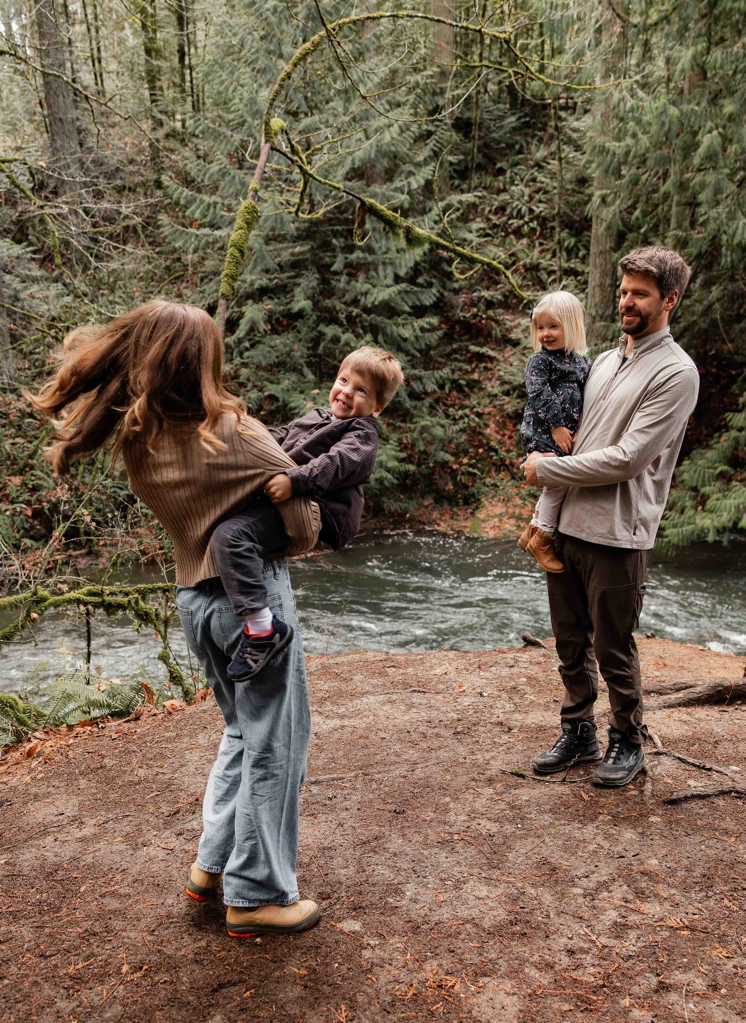 Mother spinning her toddler at Whatcom Falls Park in Bellingham, Washington 