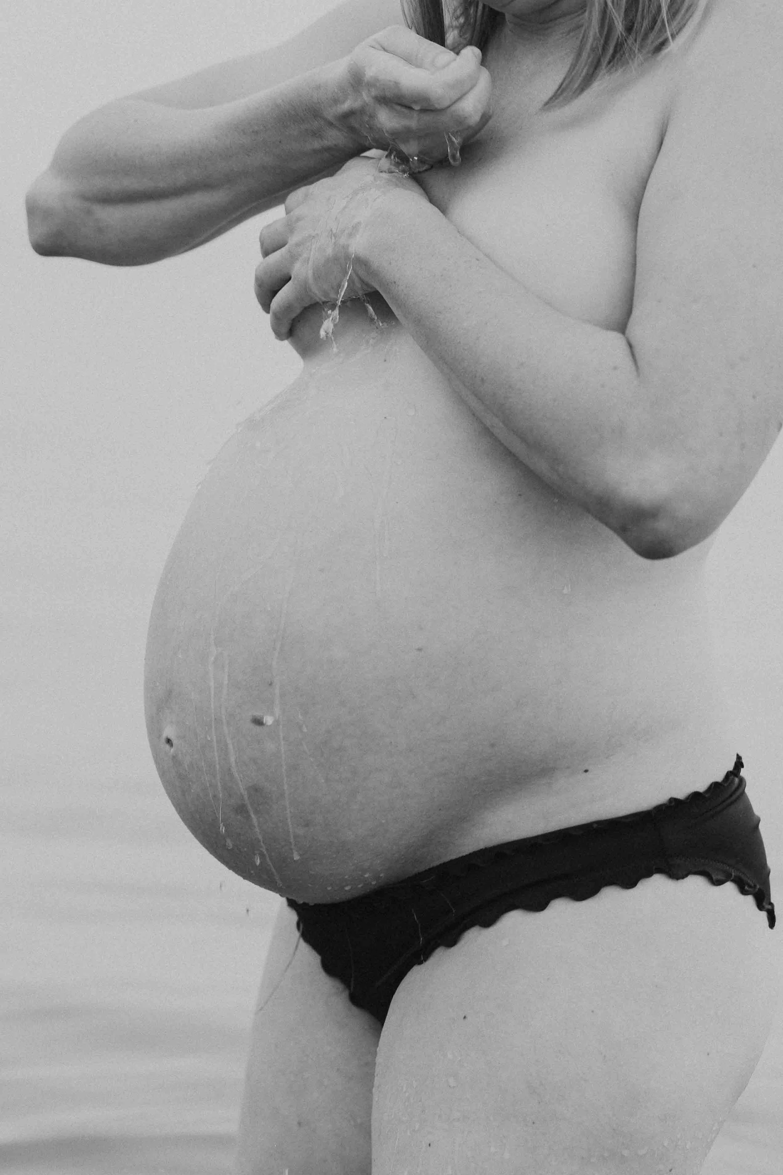 Pregnant women in water during beach maternity session