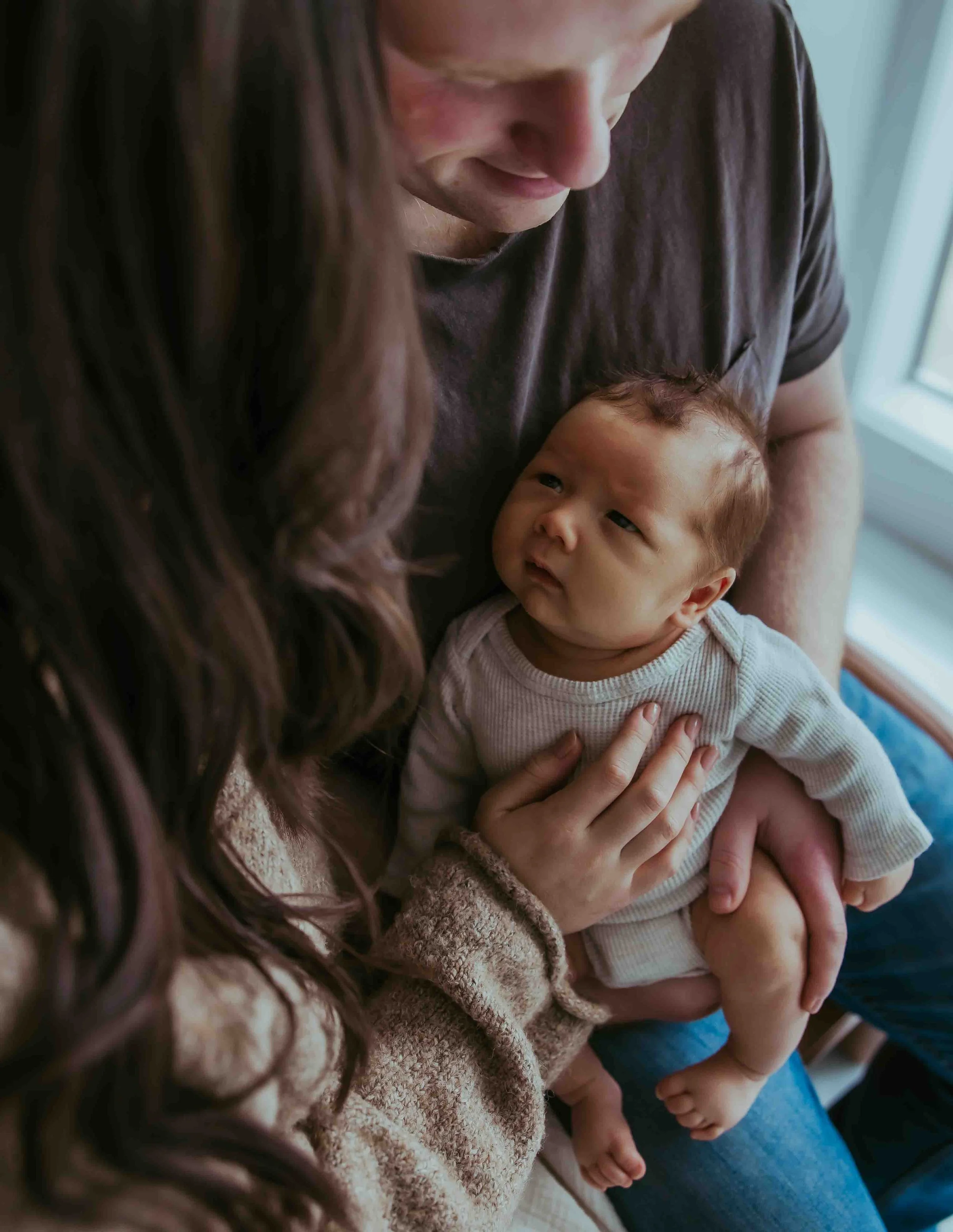 Newborn looks at parents during photography session in Lynden, Washington