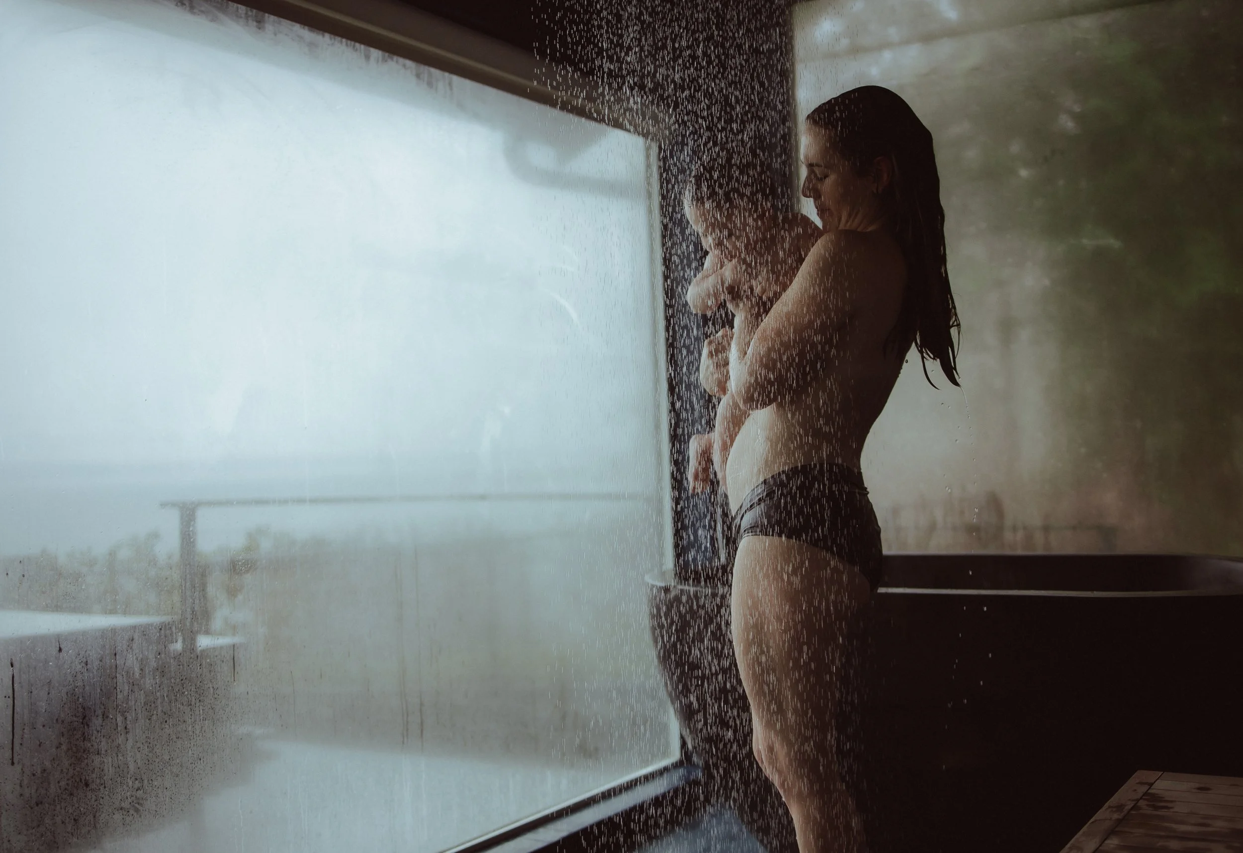 Mother holding baby during shower photography session