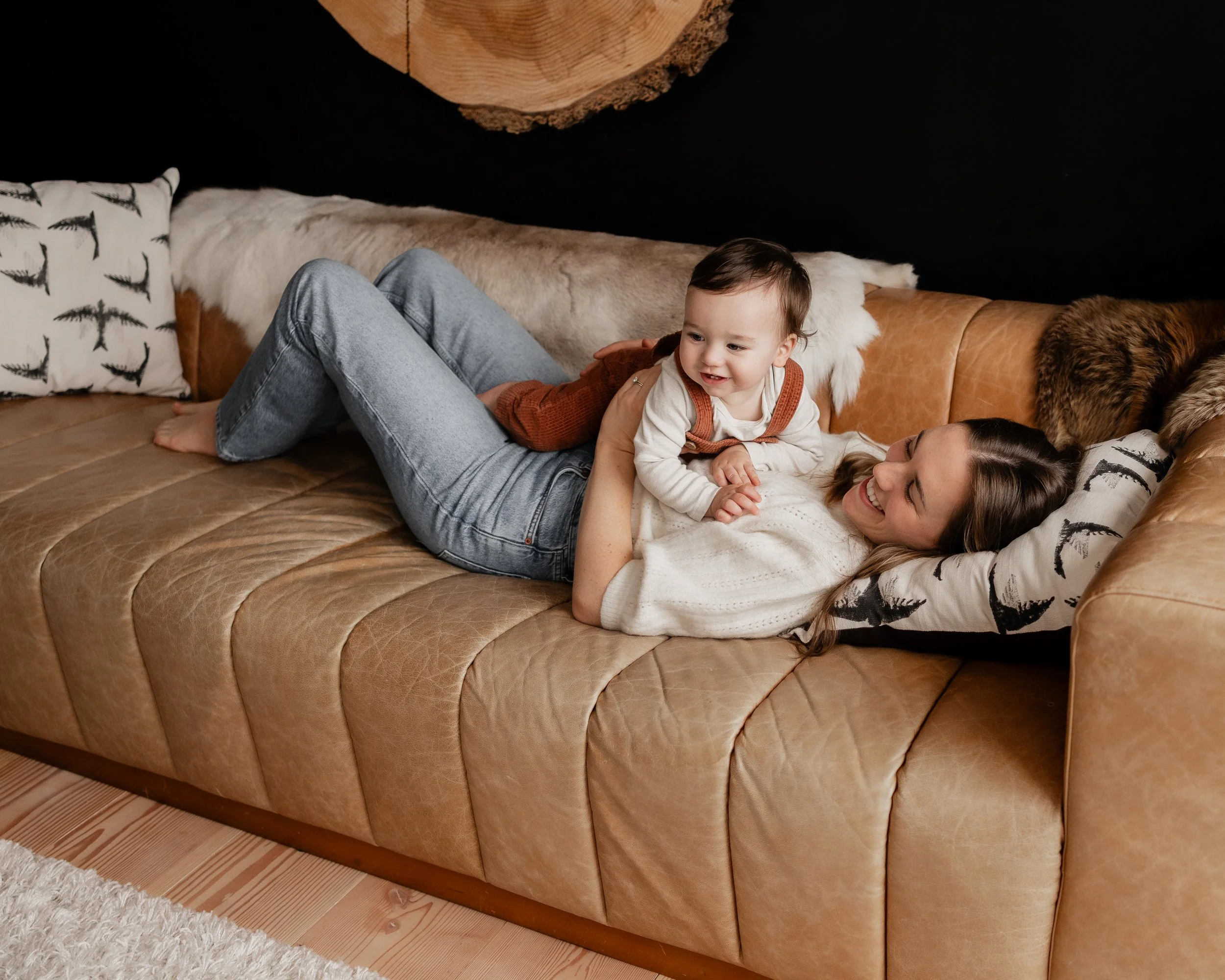 Mother and baby playing on couch