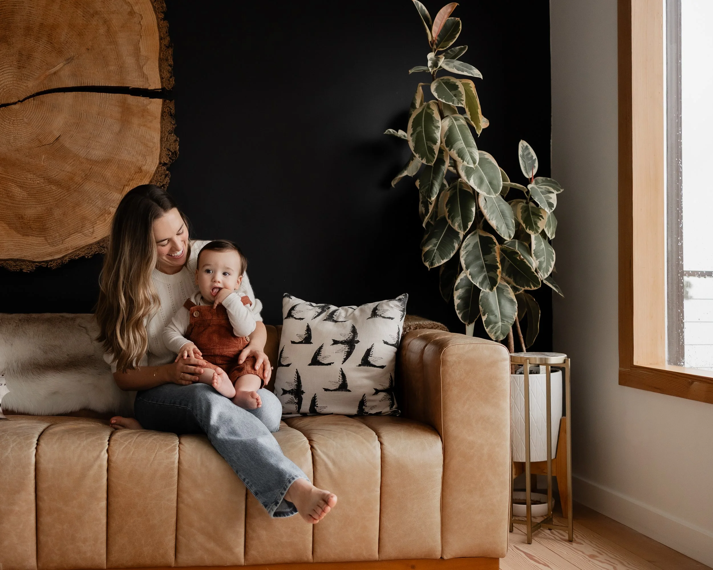 Mother and baby sitting on couch 