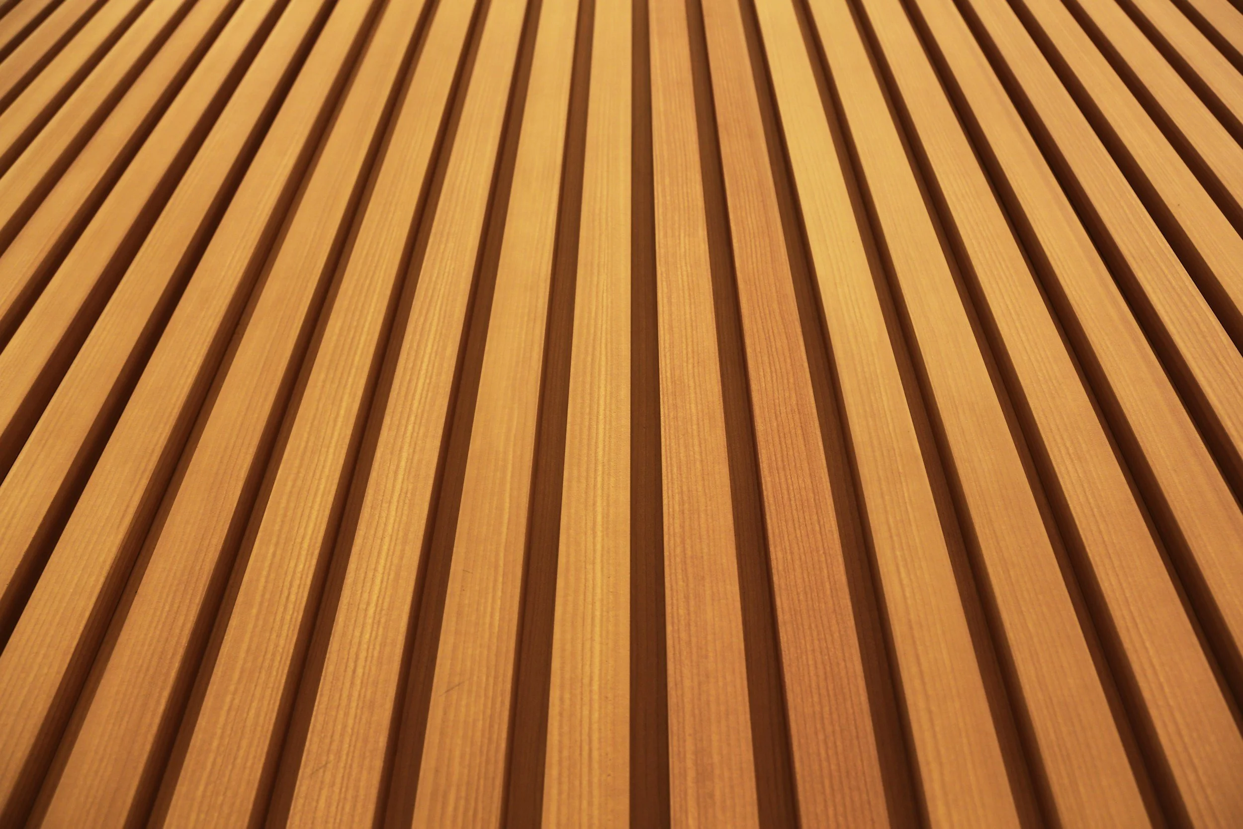 Close-up of a wooden surface with parallel grooves or slats.