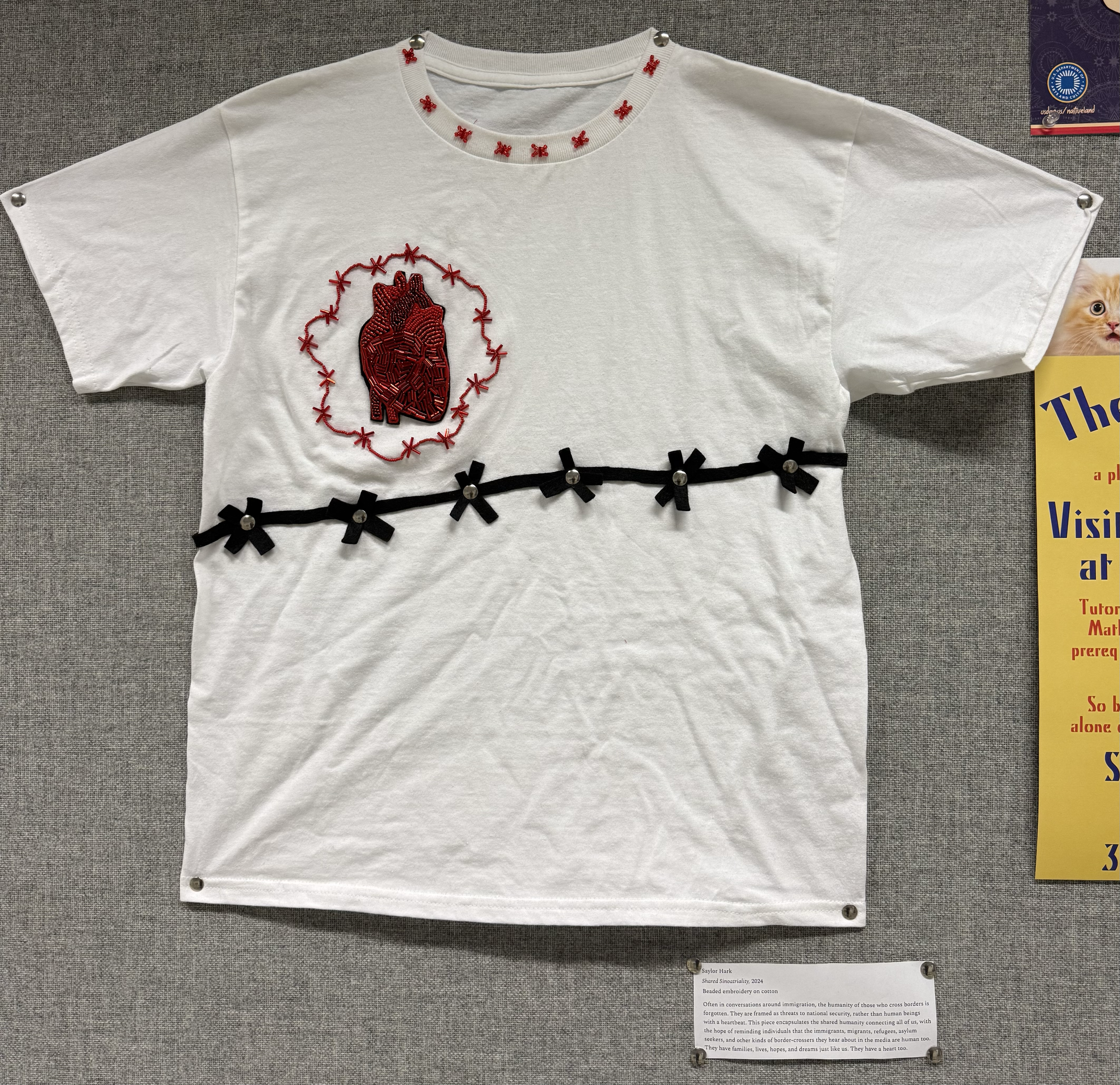 Embroidery piece titled "Shared Sinoatriality." Exhibited in the Educational Studies Department at Colgate University. This piece highlights the shared humanity of everyone regardless of citizenship status.