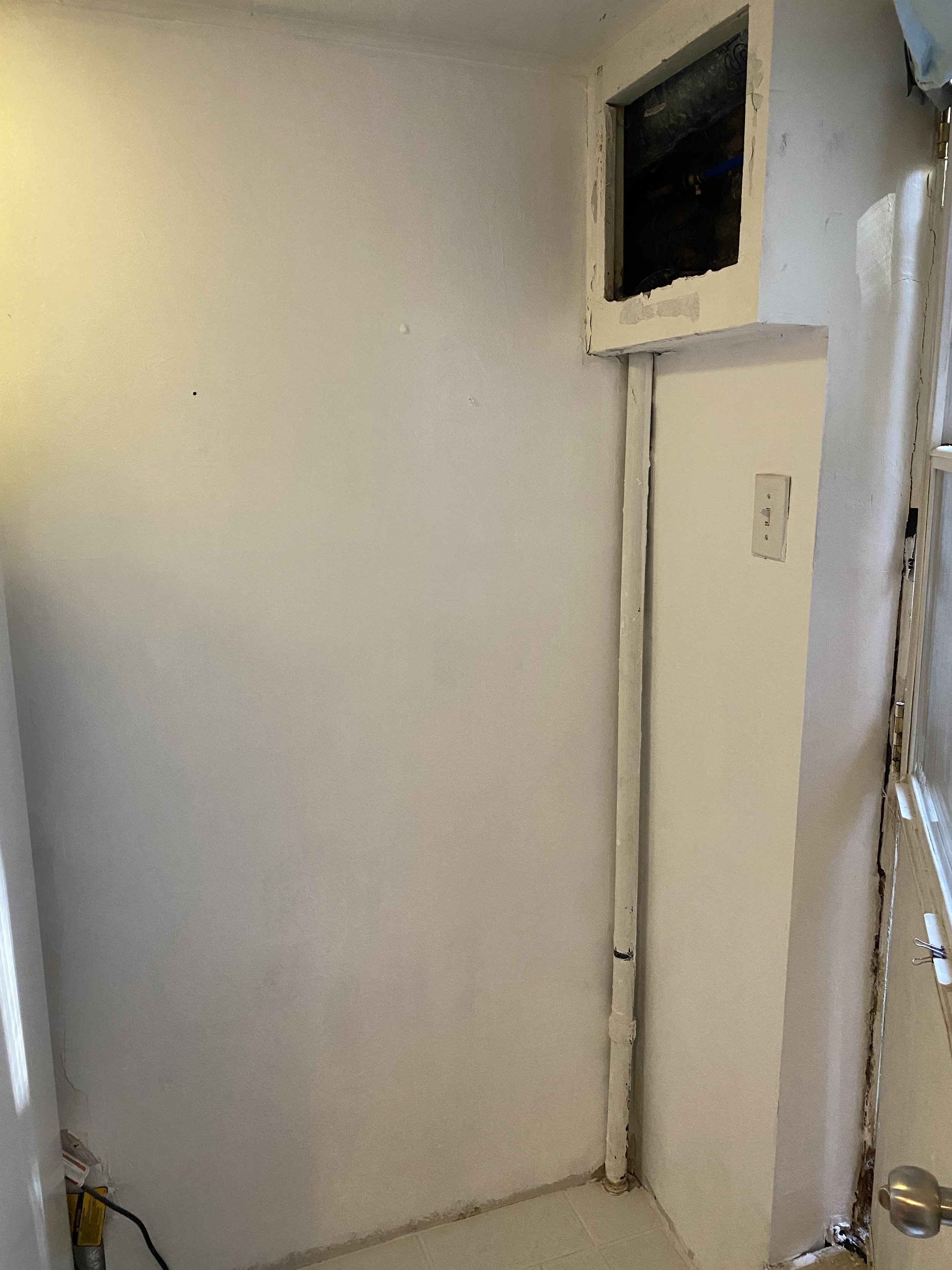 Drywall repair and surface refinishing around utility pipes in a Markham property.