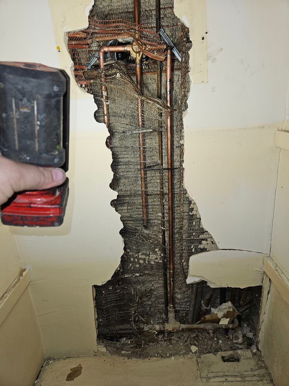 Wall opened for access to old plumbing lines