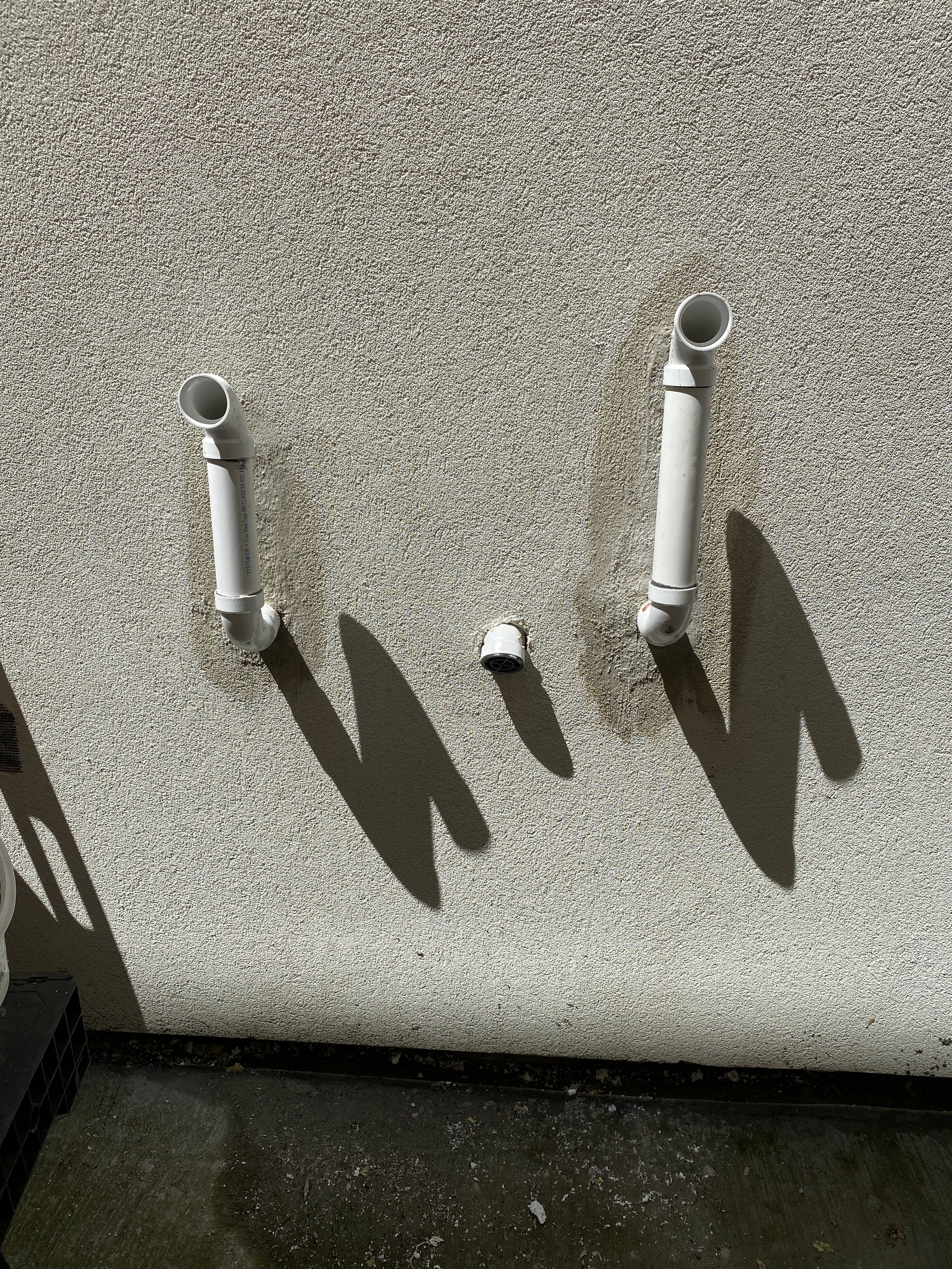 Exhaust Pipe Extension and Stucco Wall Restoration