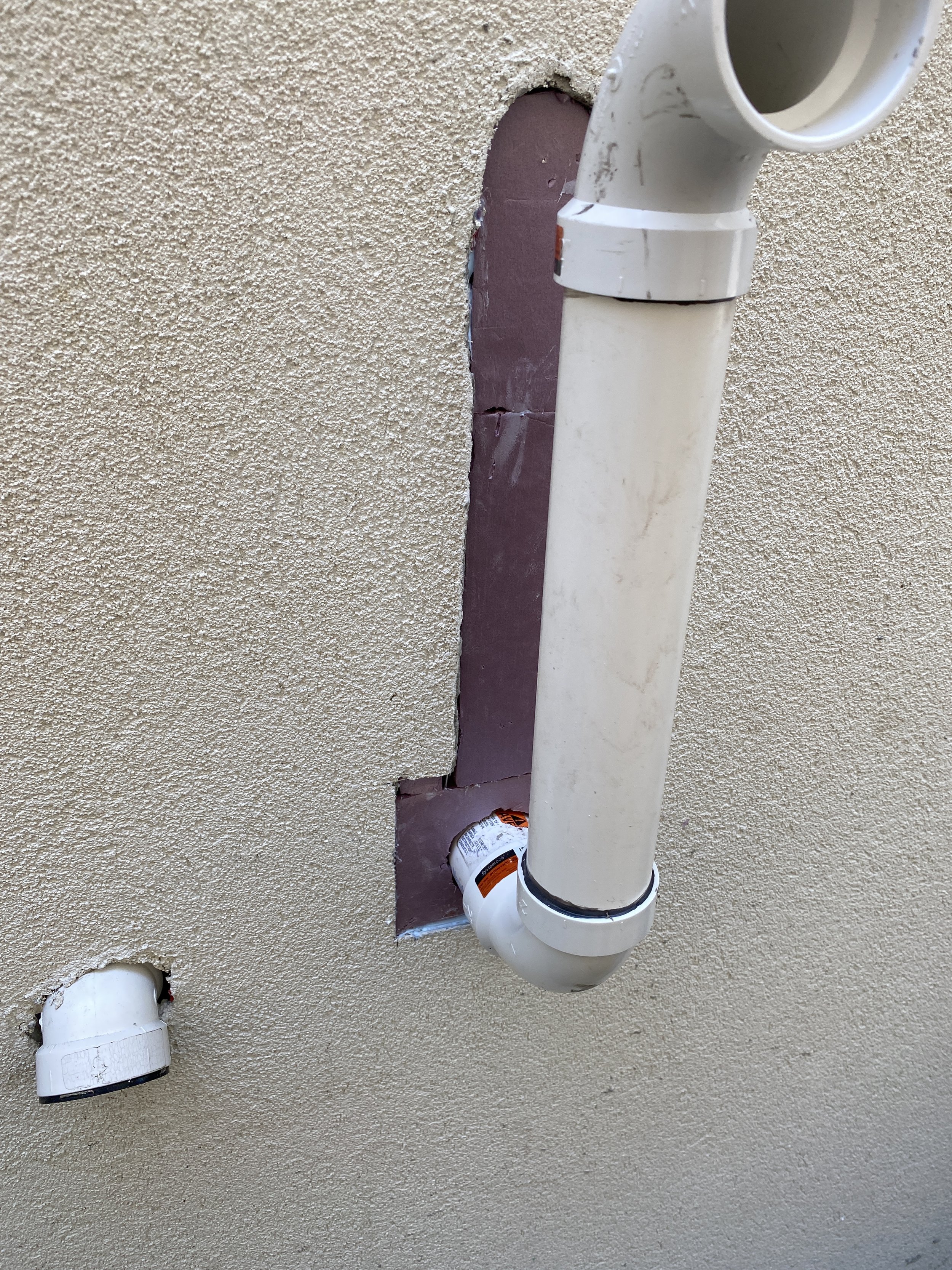 Patch and restore stucco surface around newly extended pipes