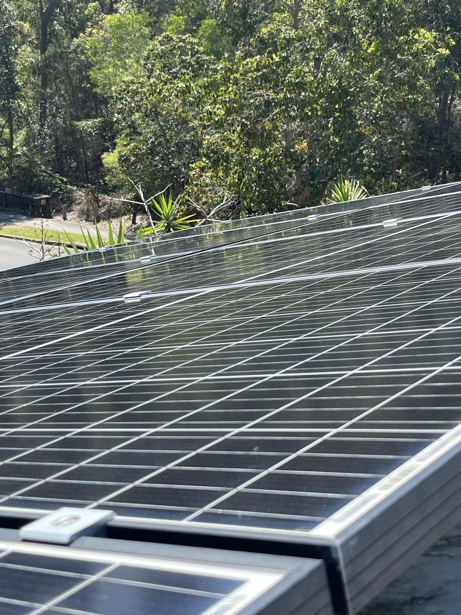 Wooden cabin near a lake with mountains in the background and grassy landscape