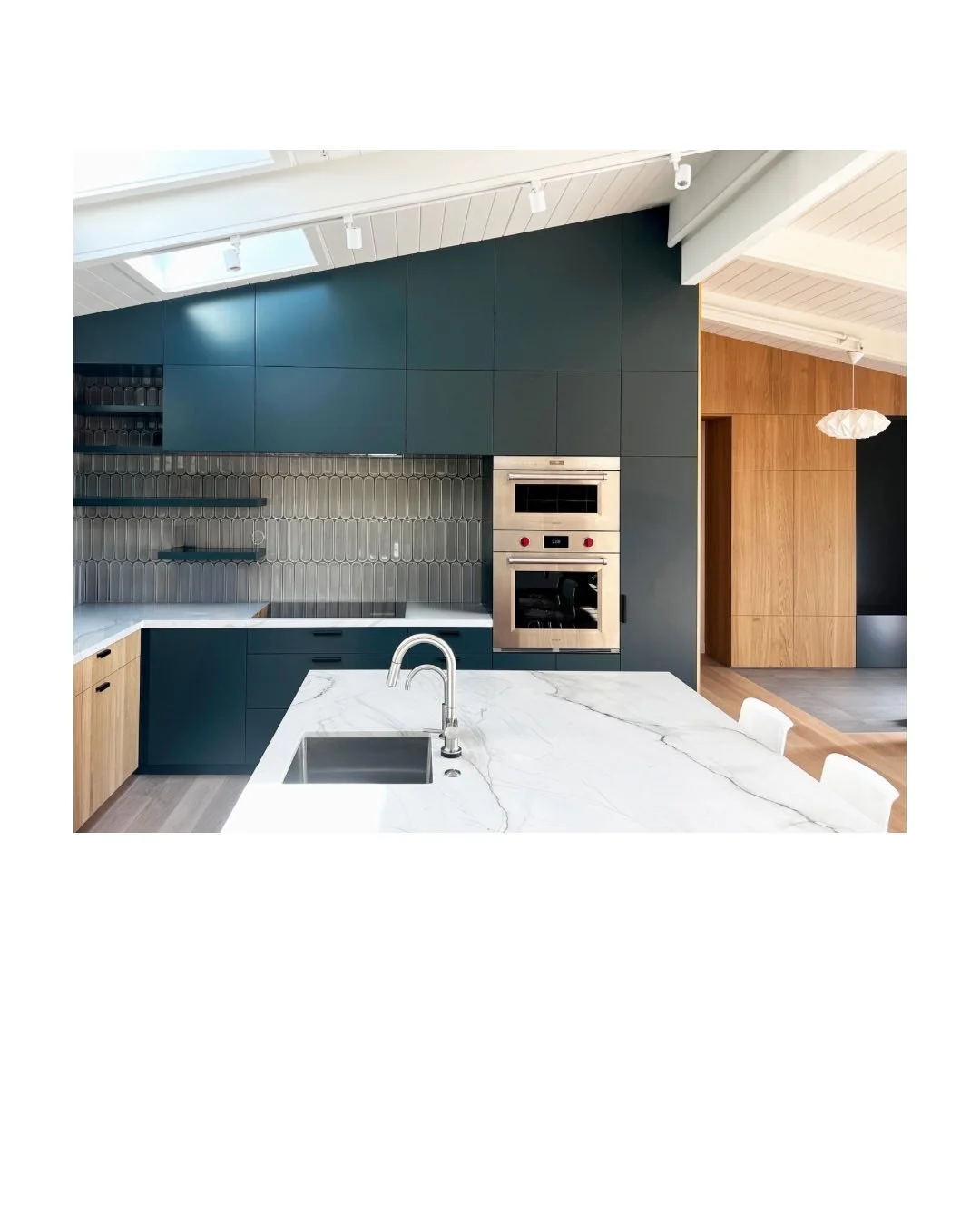 Our recently completed Marin remodel. This is a view of the kitchen and the entryway beyond. The goal was to open up the home to more light and views as well as establish an outdoor entertaining area. Visit our website to view the project!