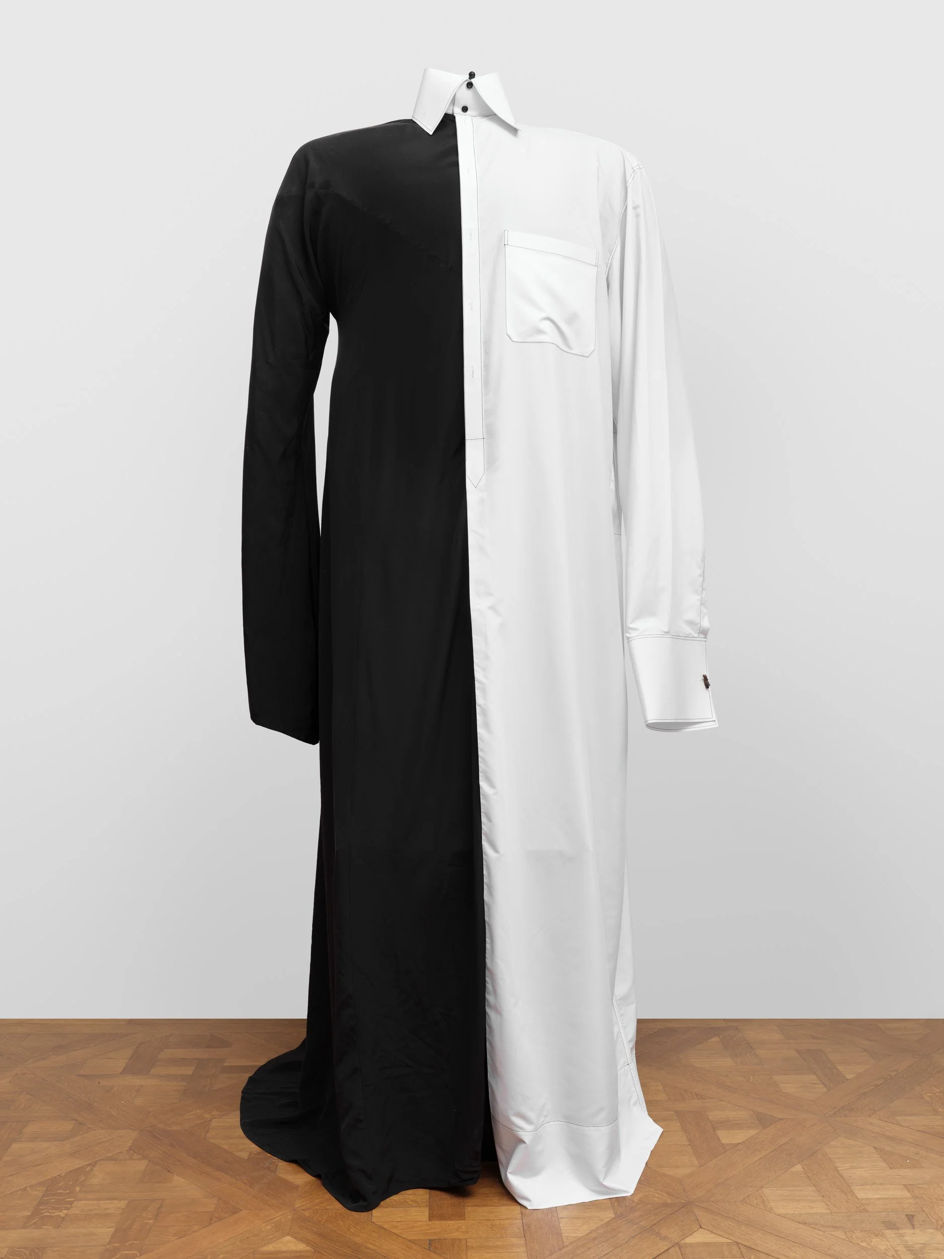 A dress shirt designed with split colors, black on the left side and white on the right side, featuring a white collar and a pocket on the right chest.