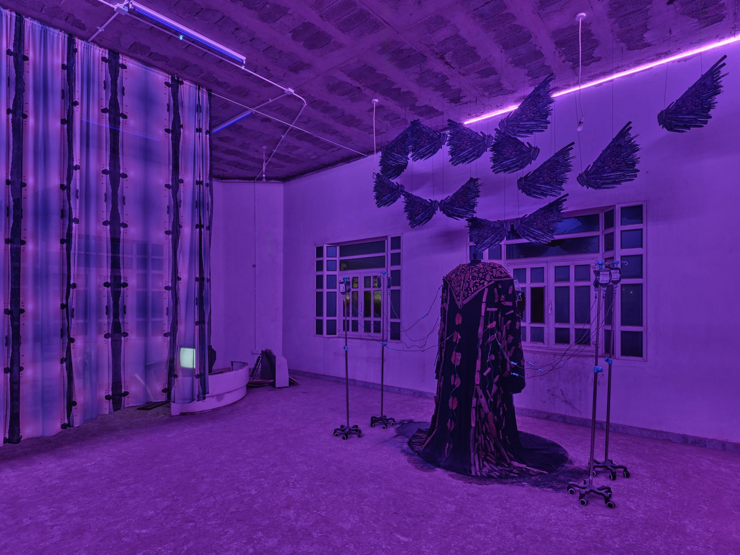 Right Room: IV Hospital
A hospital-like environment in which the Oud Abaya is positioned within a state of care. The space is not entered and is observed from the outside.

The  Oud Abaya is cared for by a nurse, reinforcing a condition of maintenanc