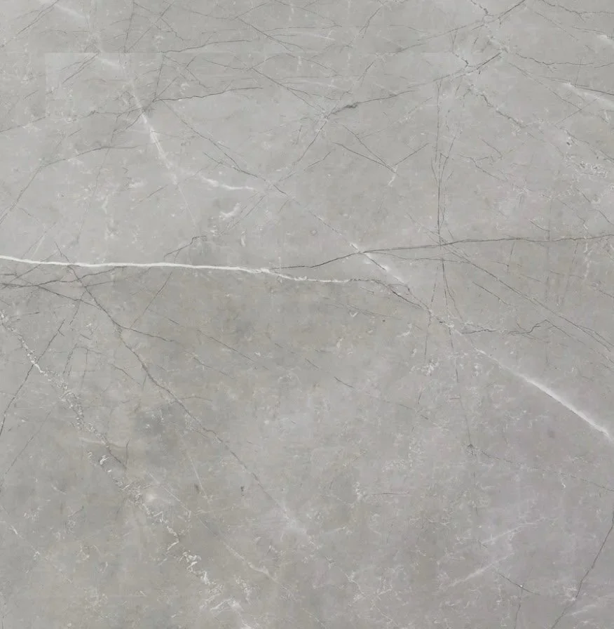 Close-up of a gray marble surface with natural veins and cracks.