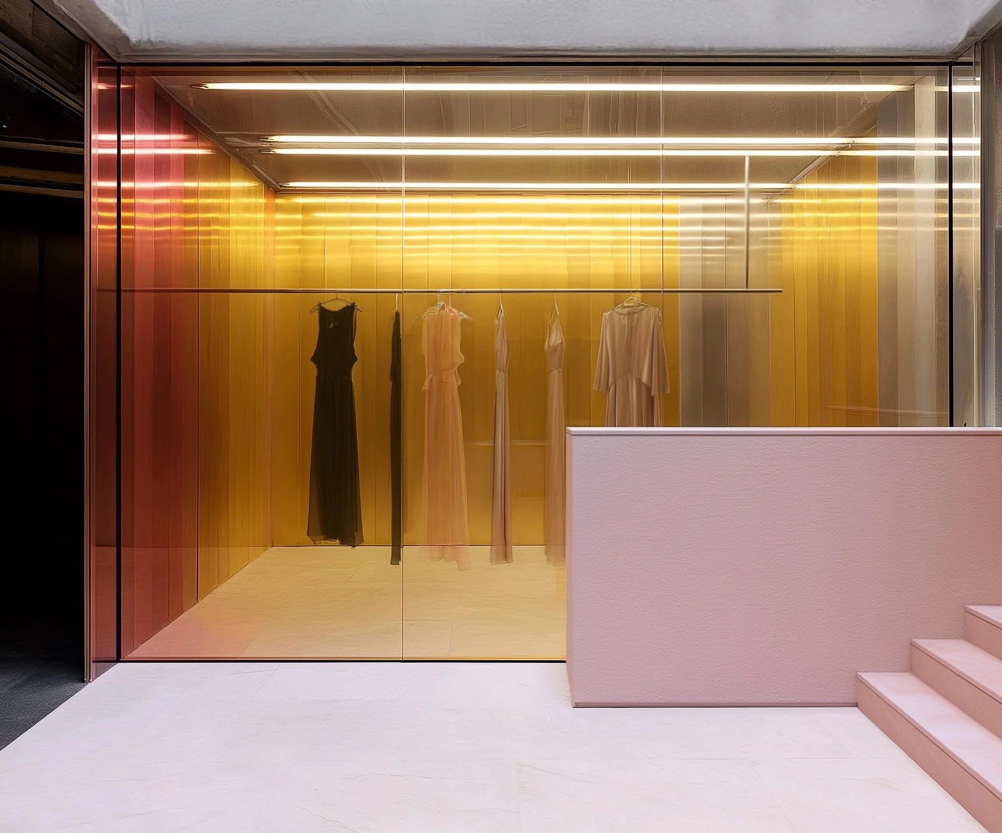 Storefront of window display with dresses hanging on a rod, illuminated by yellow and white lighting, with steps leading up to the right, of a modern and creative retail design project of a fashion store, a commercial design project