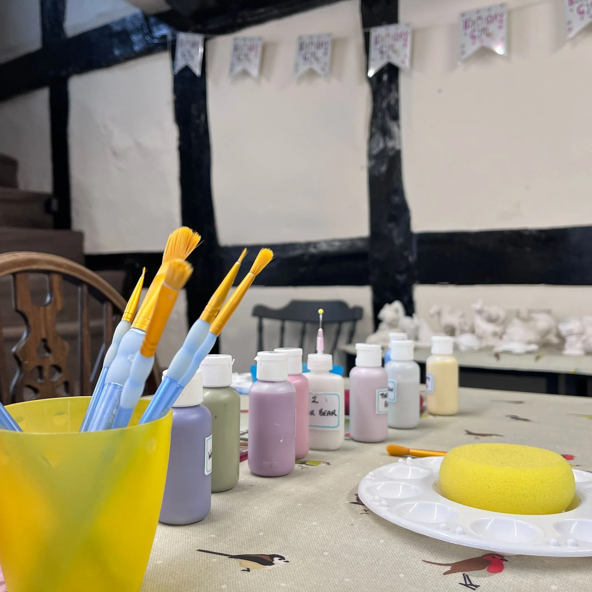 paint brushed and paints on a table.jpeg