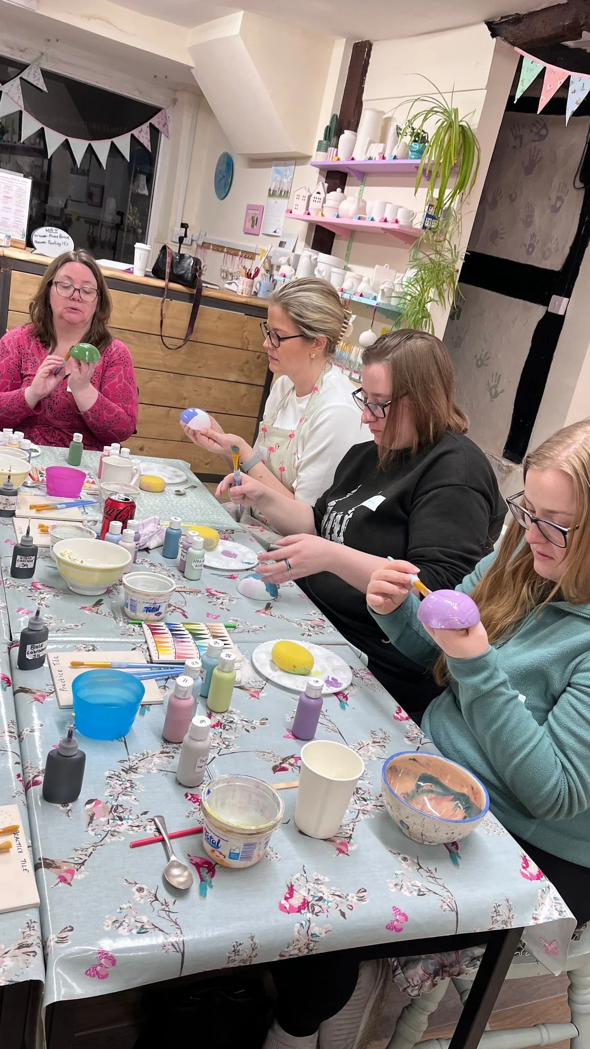 four women painting pots.jpeg