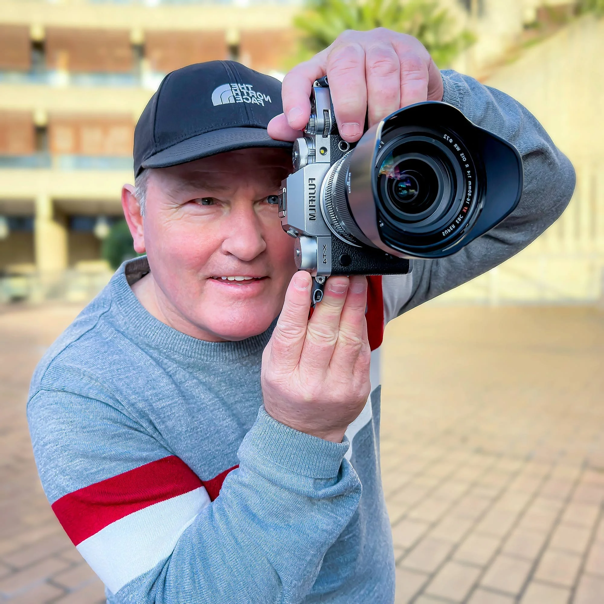 Profile Photo of Mark Roche with a camera to introduce himself on the about page at Mark Roche Photography.