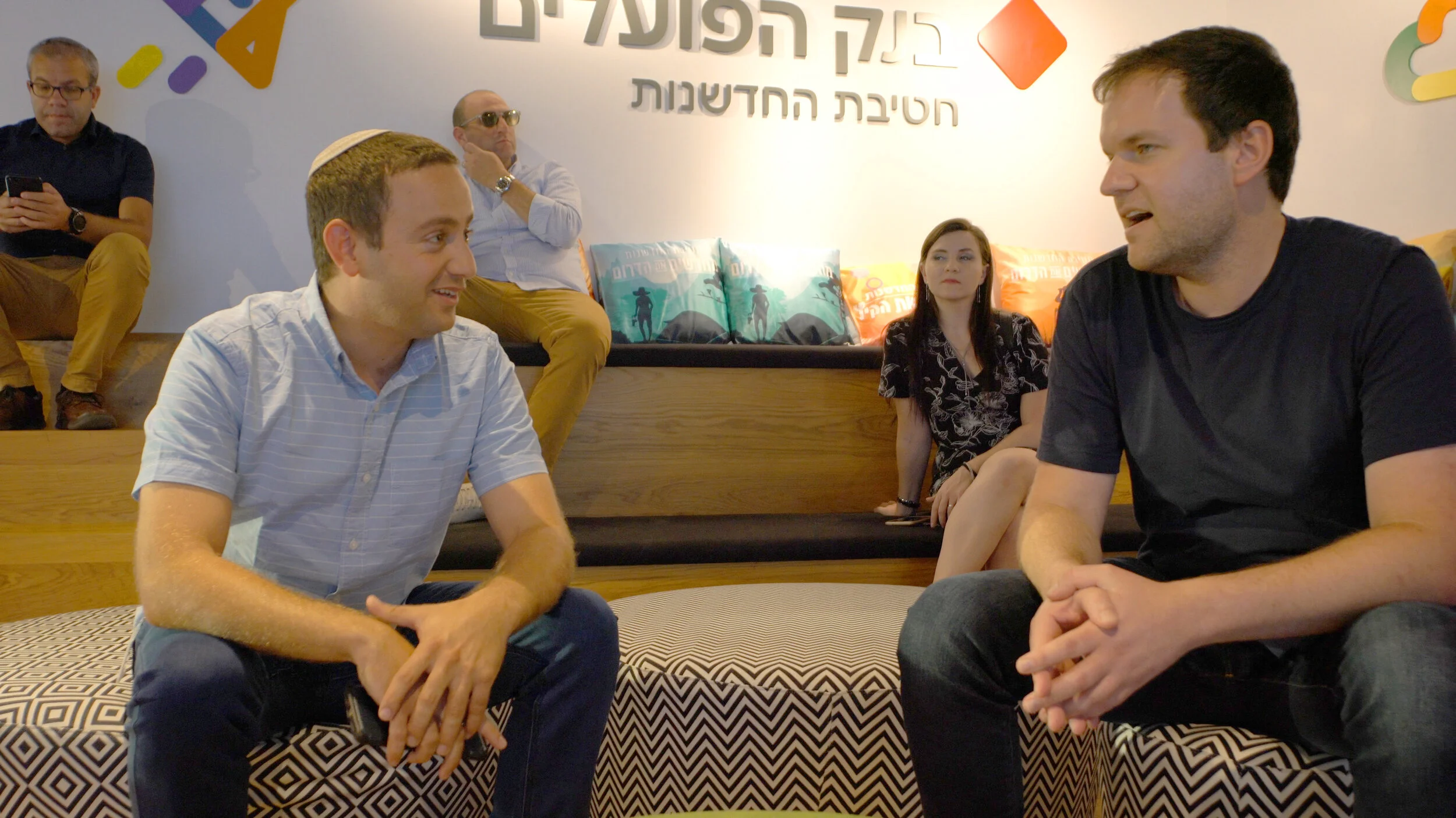 American fellow, Adam, interacting with an Israeli fellow at Bank Hapoalim.