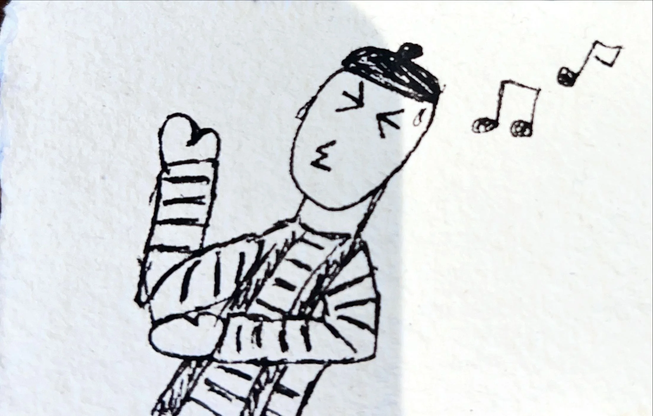Hand-drawn sketch of a person singing or humming, with eyes closed and musical notes nearby.